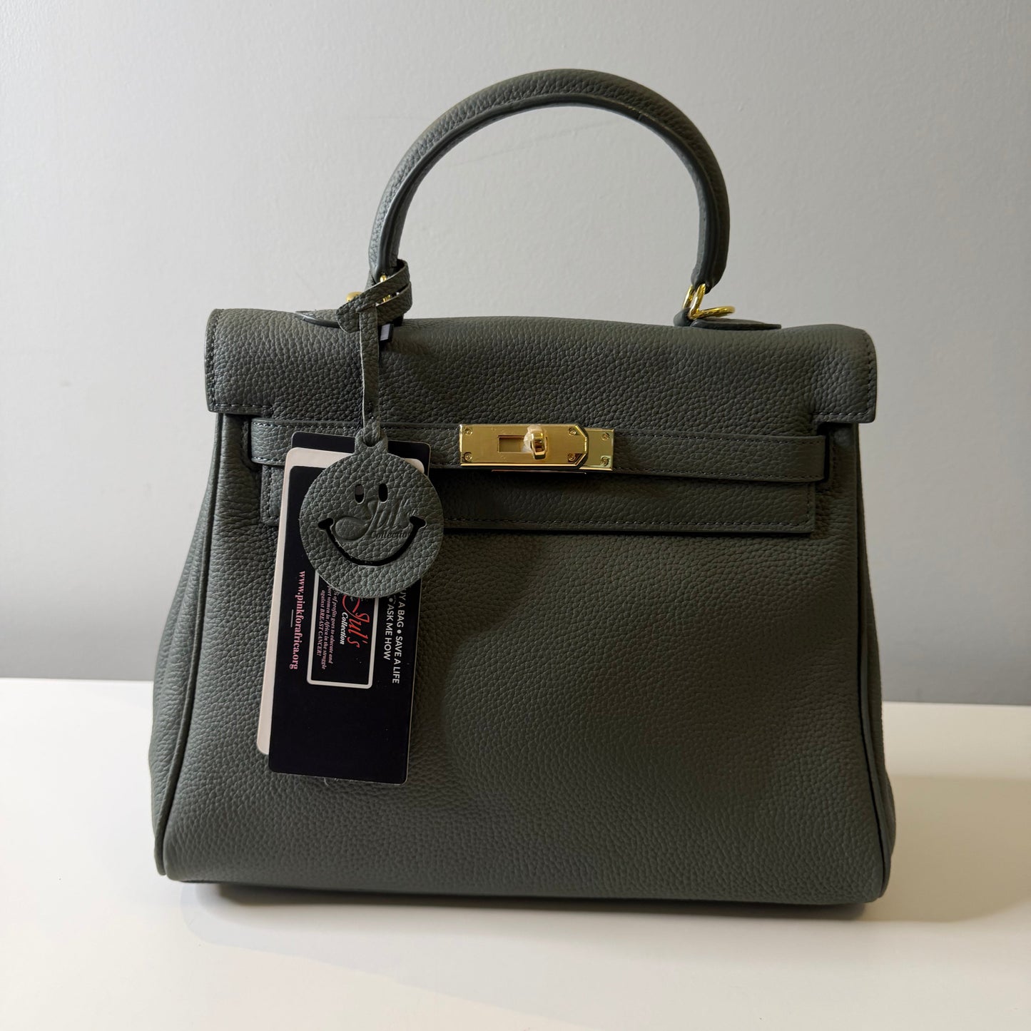 Black handbag with gold clasp on a white background