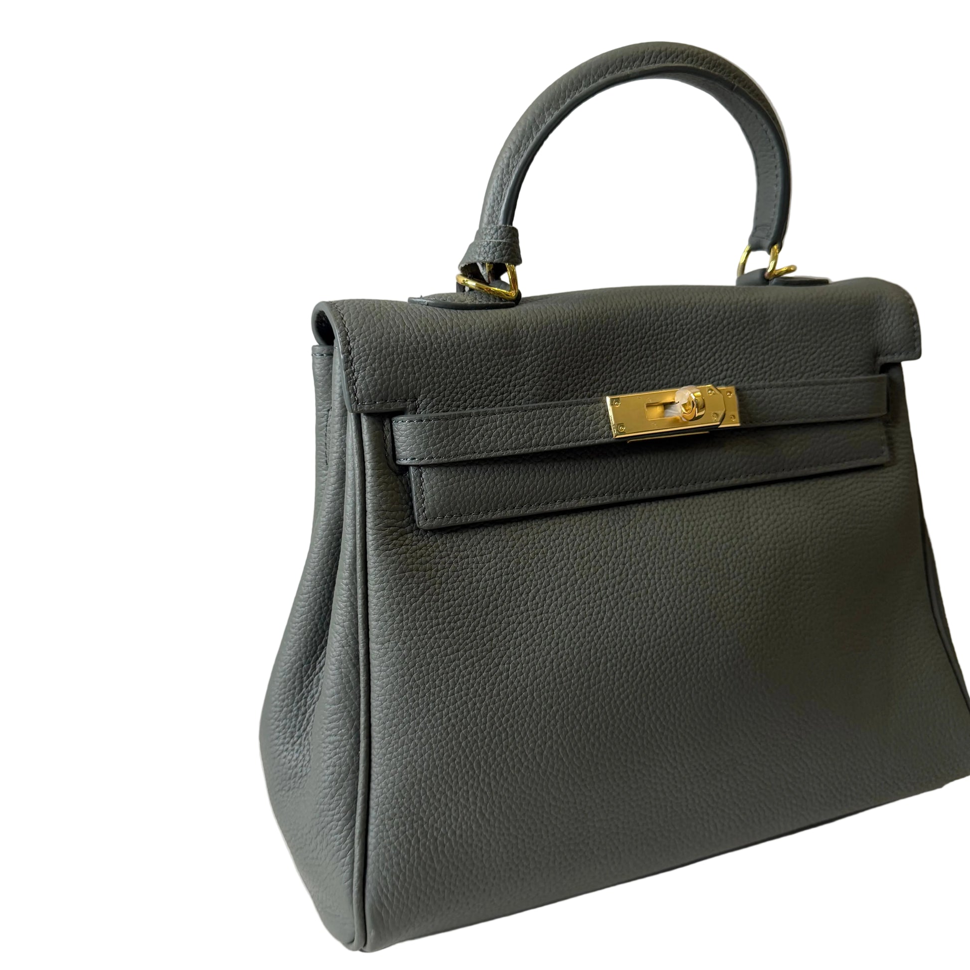 Black handbag with gold accents on a light gray background