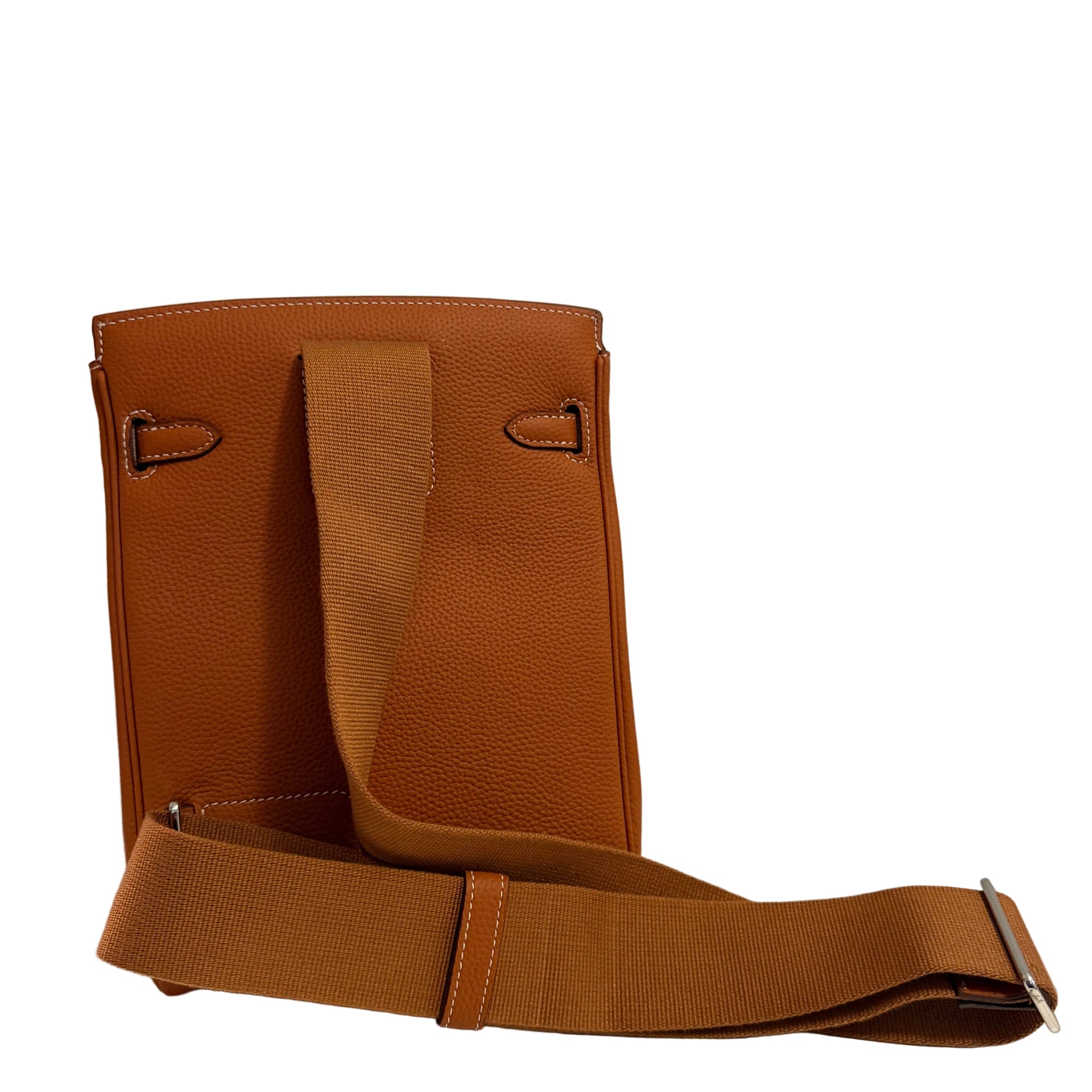 Brown leather bag with a strap on a light gray background