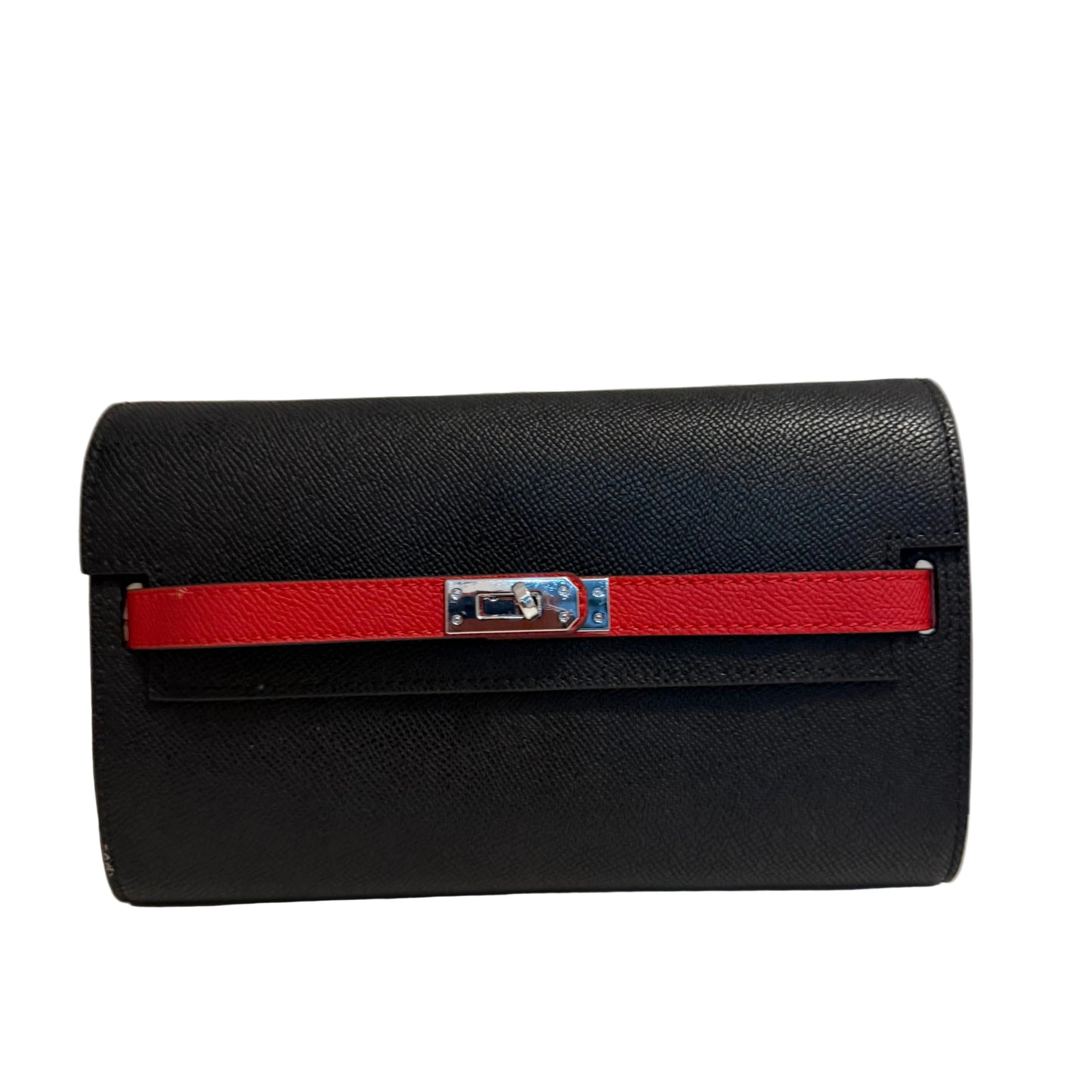 Black handbag with a red strap on a light gray background