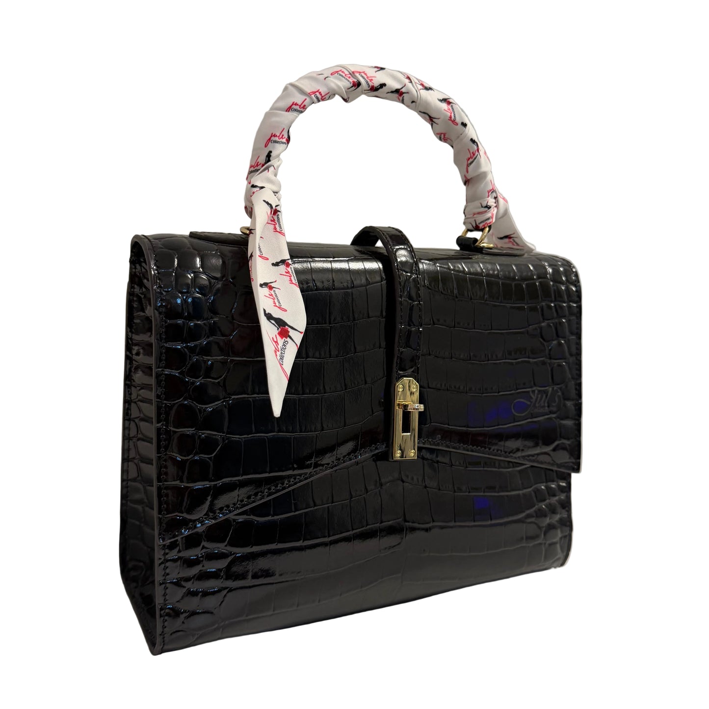 Black crocodile-patterned handbag with a decorative handle on a white surface.