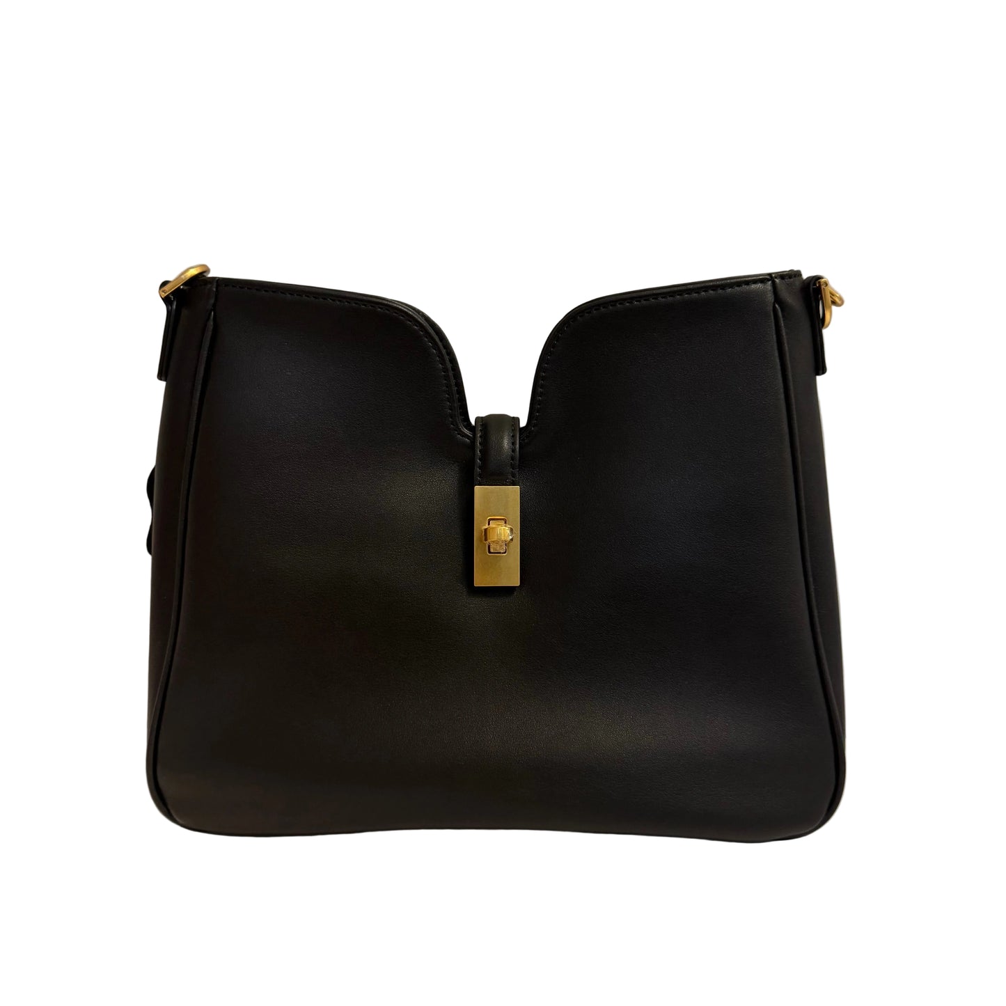Black handbag with gold clasp on a light gray background