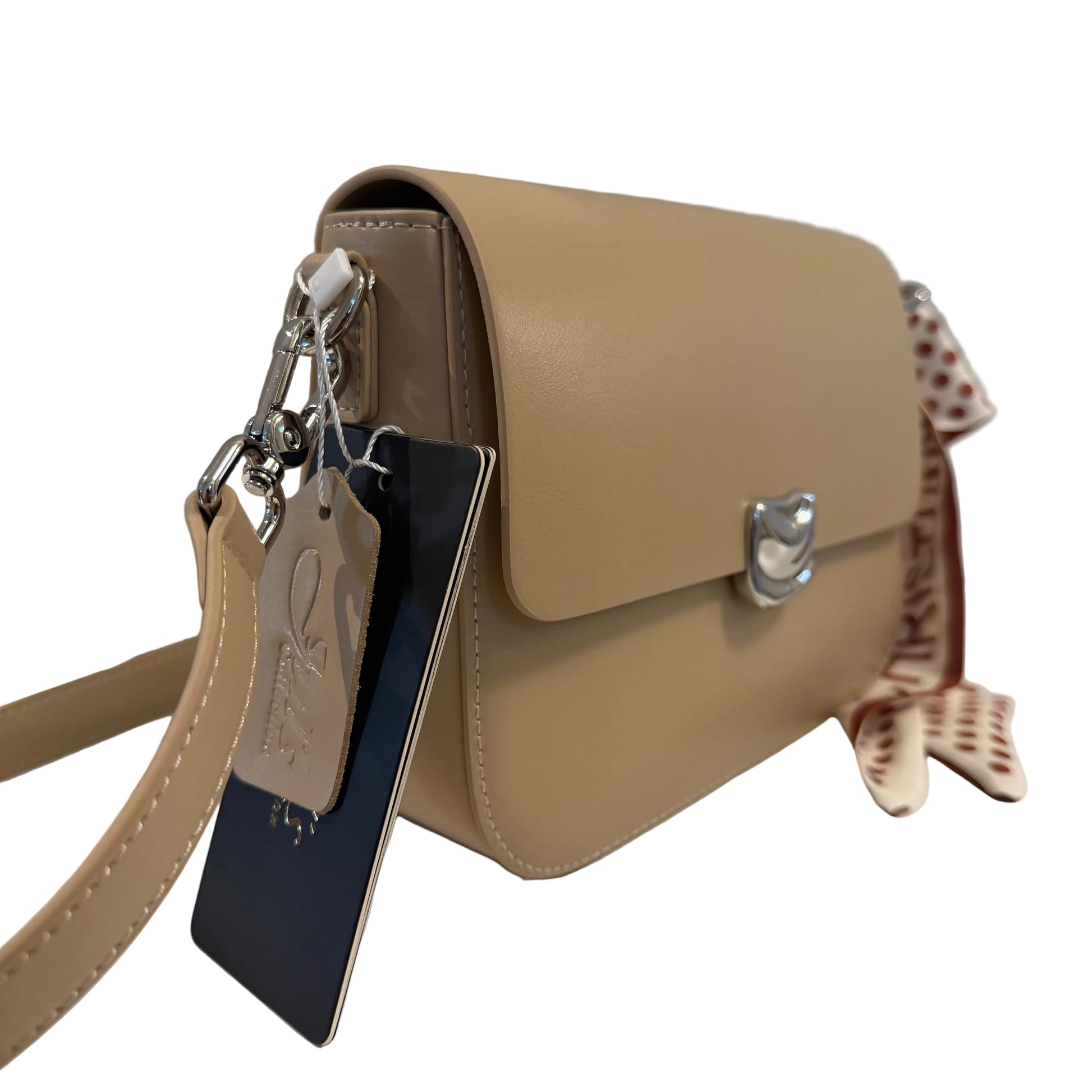 Beige handbag with a strap and decorative bow on a light gray background