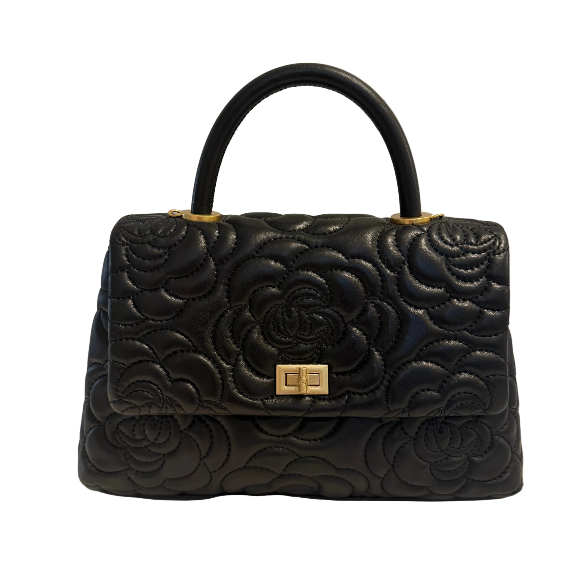 Black quilted handbag with floral design on a light background