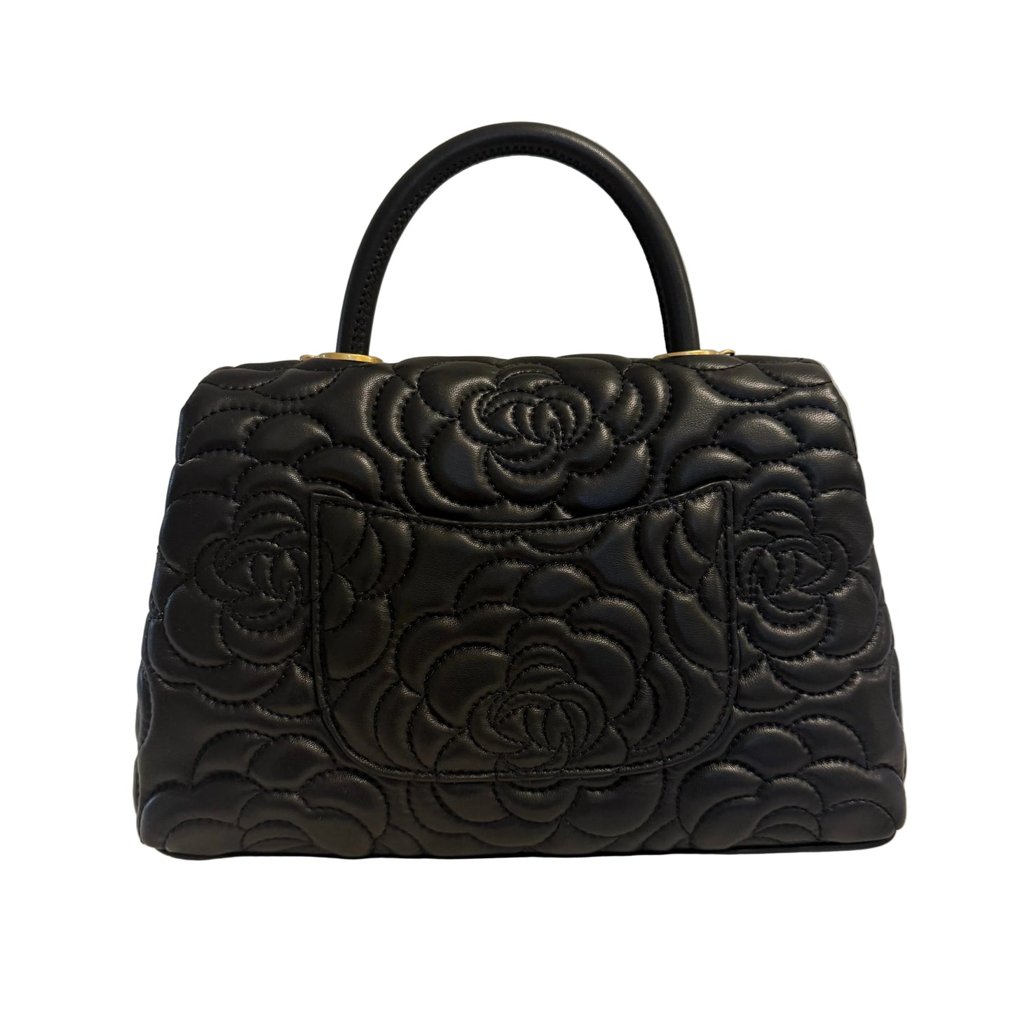 Black quilted handbag with floral patterns on a light gray background