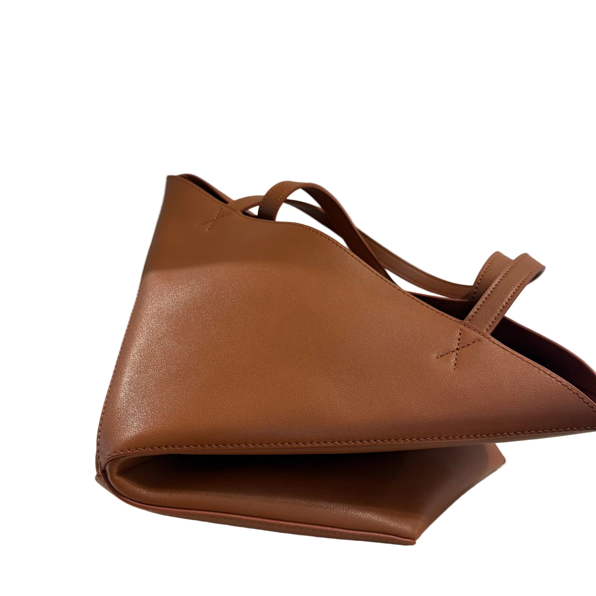 Brown leather bag on a light gray background
