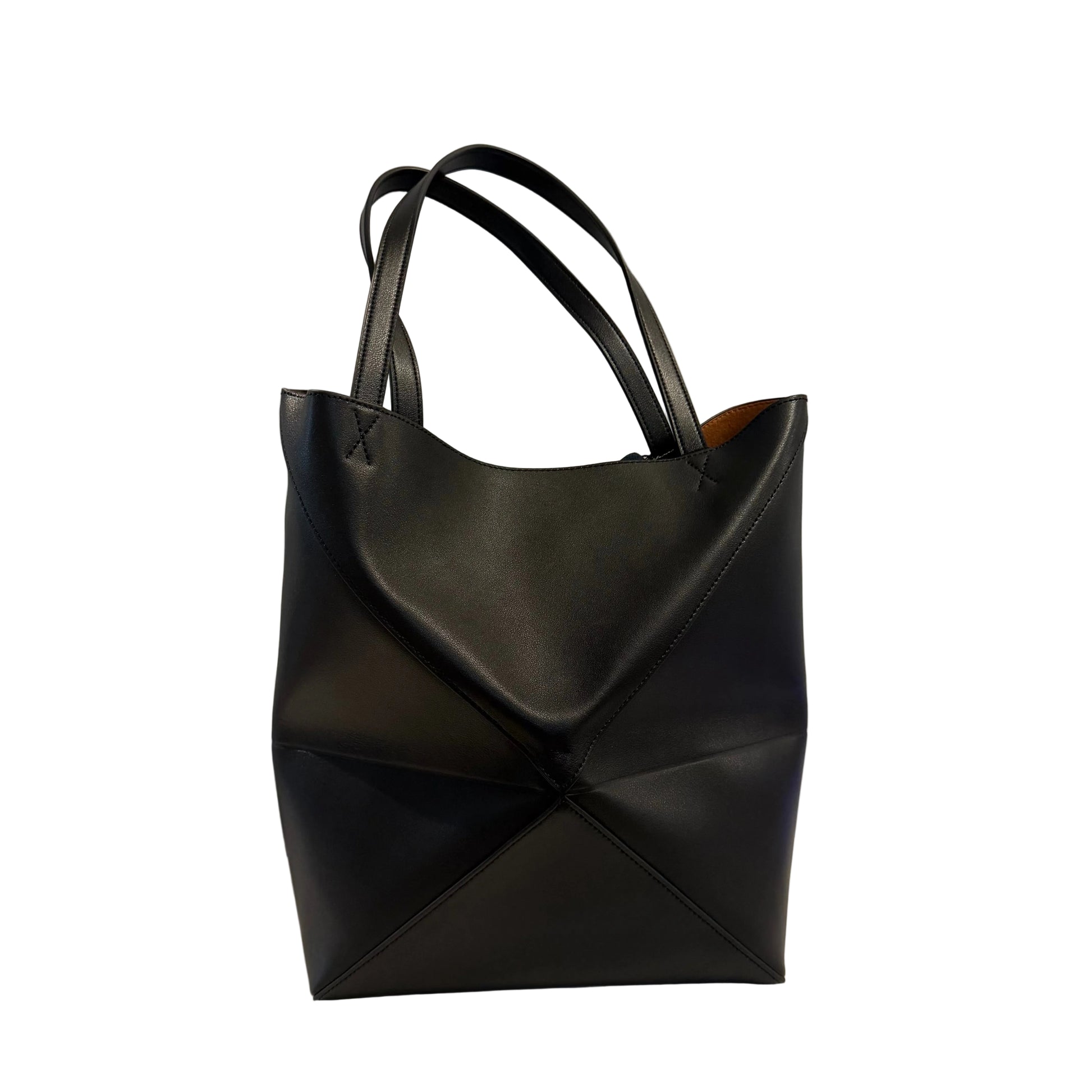Black leather tote bag on a light gray background