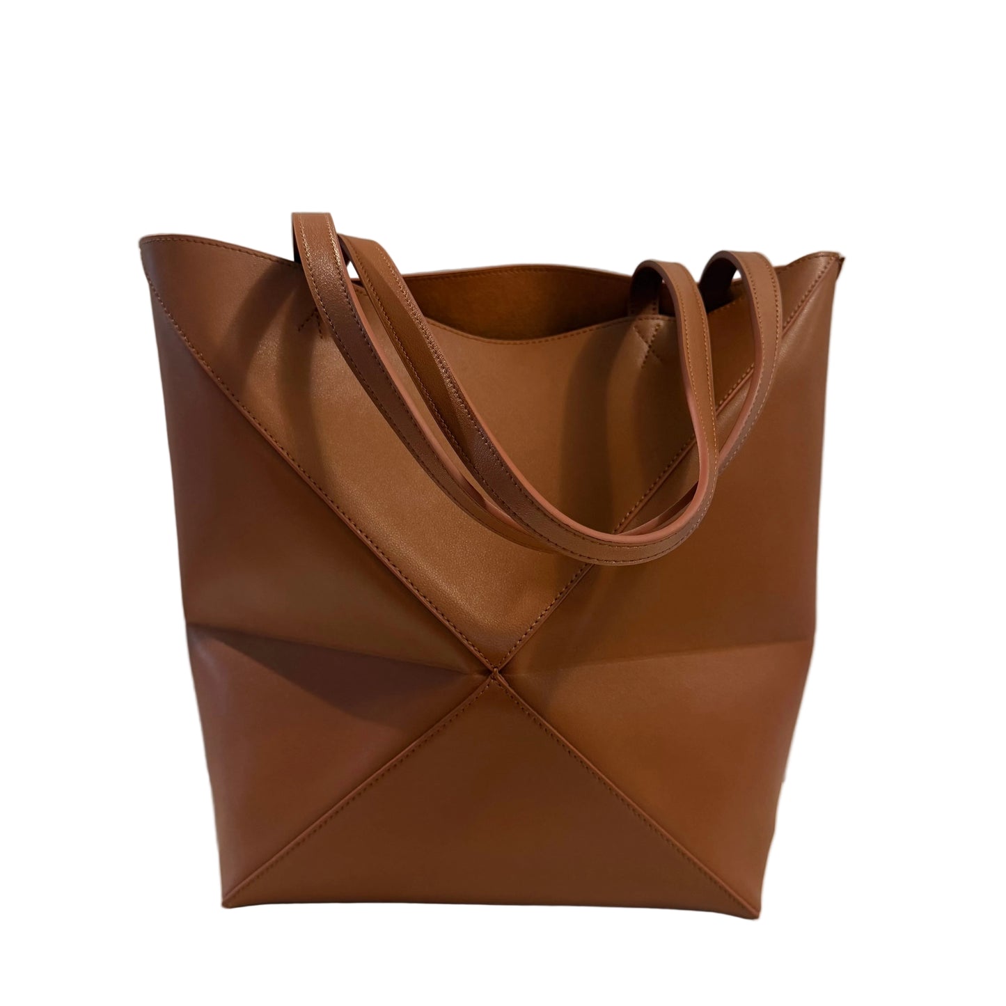 Brown leather tote bag on a light gray background