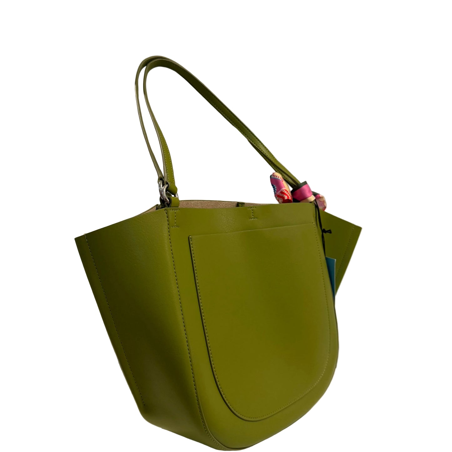 Green handbag on a white surface with a gray background