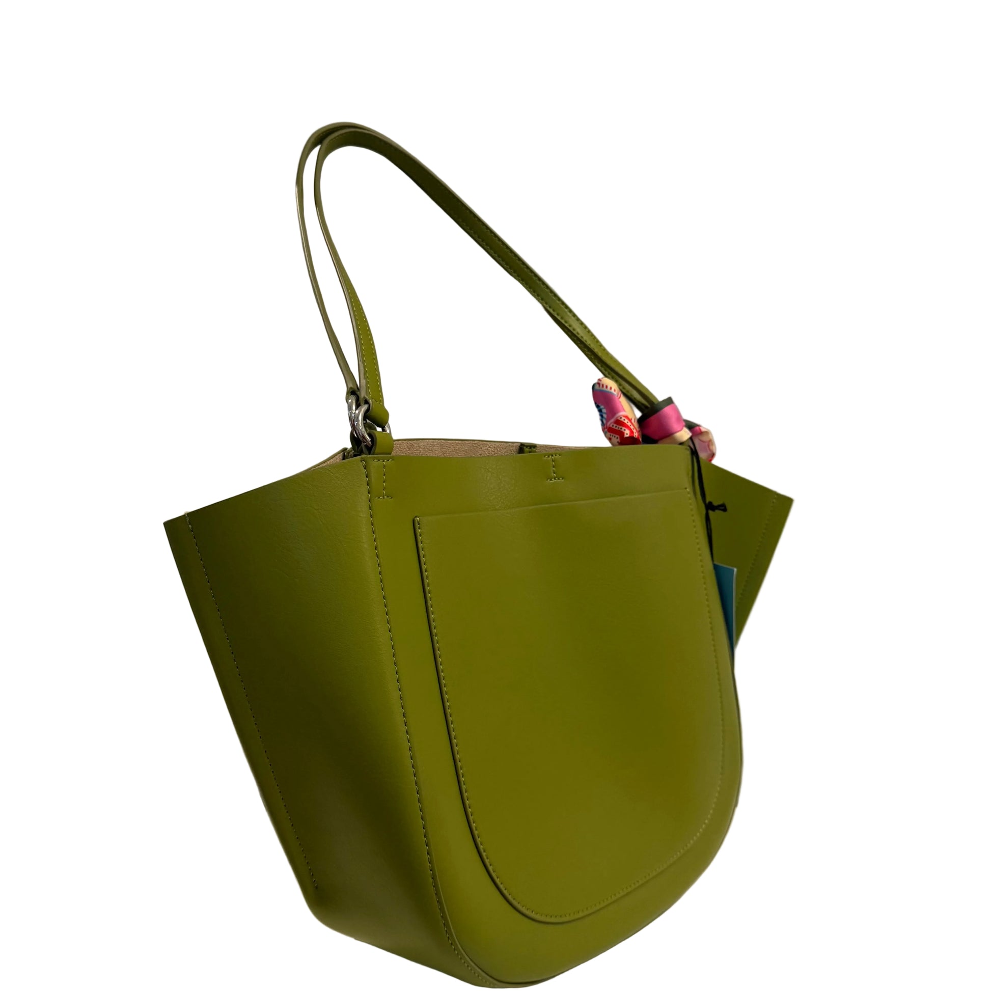 Green handbag on a white surface with a gray background
