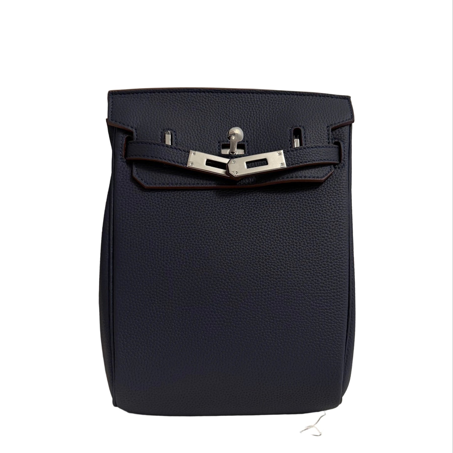 Navy blue leather bag with silver buckle on a neutral background