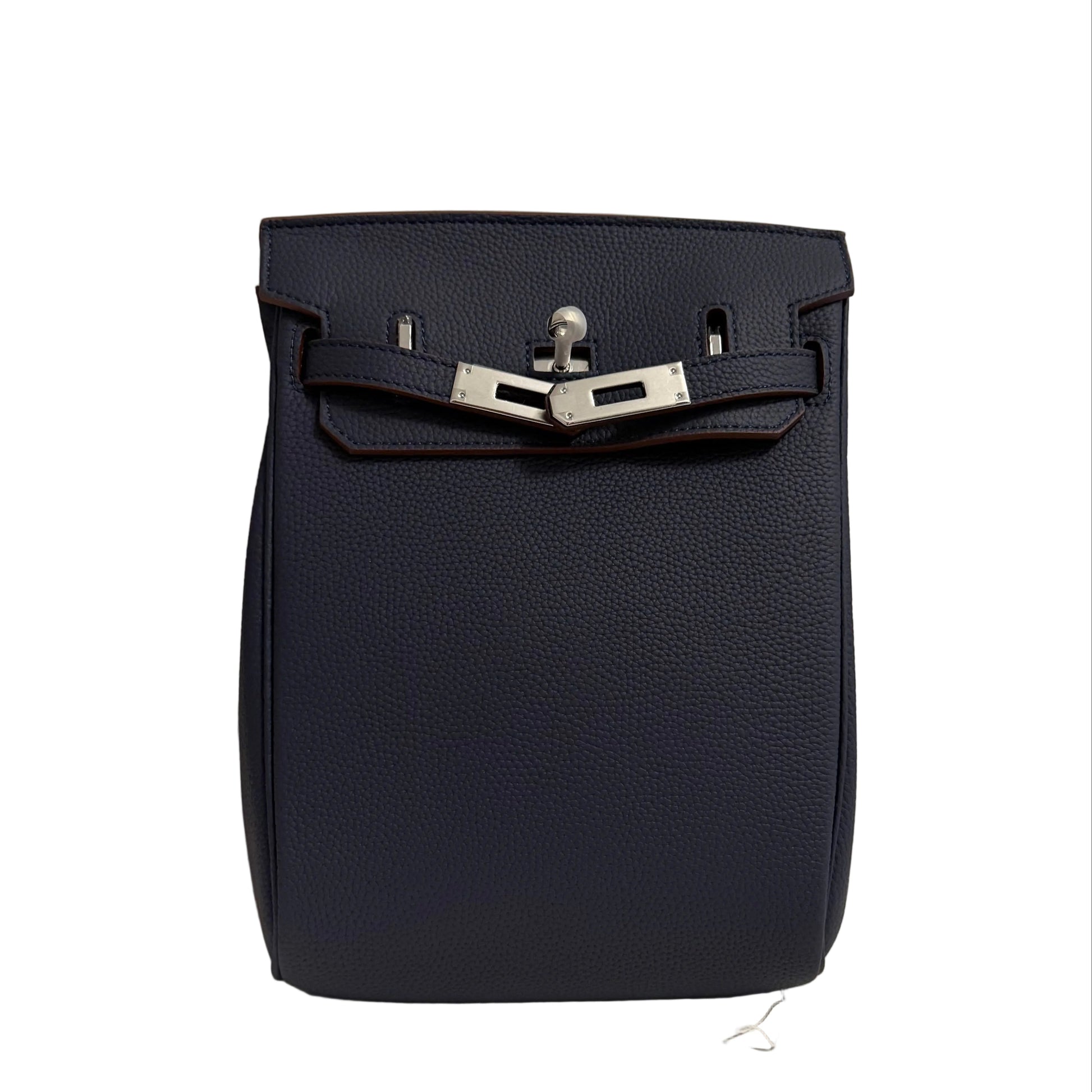Navy blue leather bag with silver buckle on a neutral background