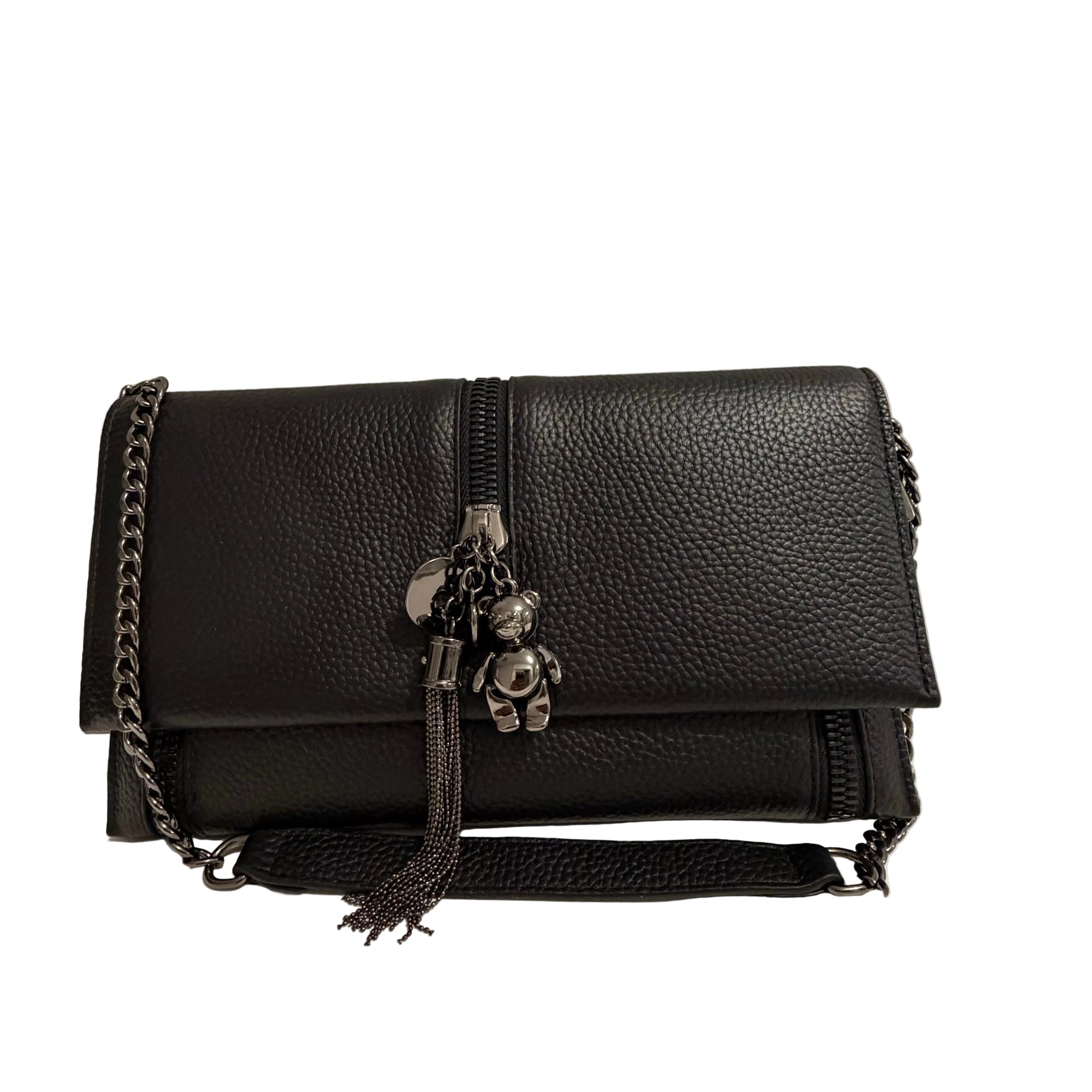 Black leather handbag with a teddy bear charm on a neutral background