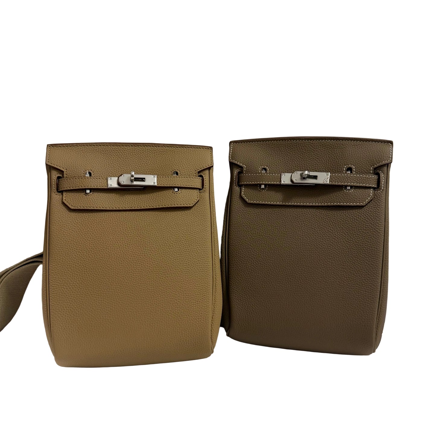 Two brown leather bags with silver hardware on a light gray background