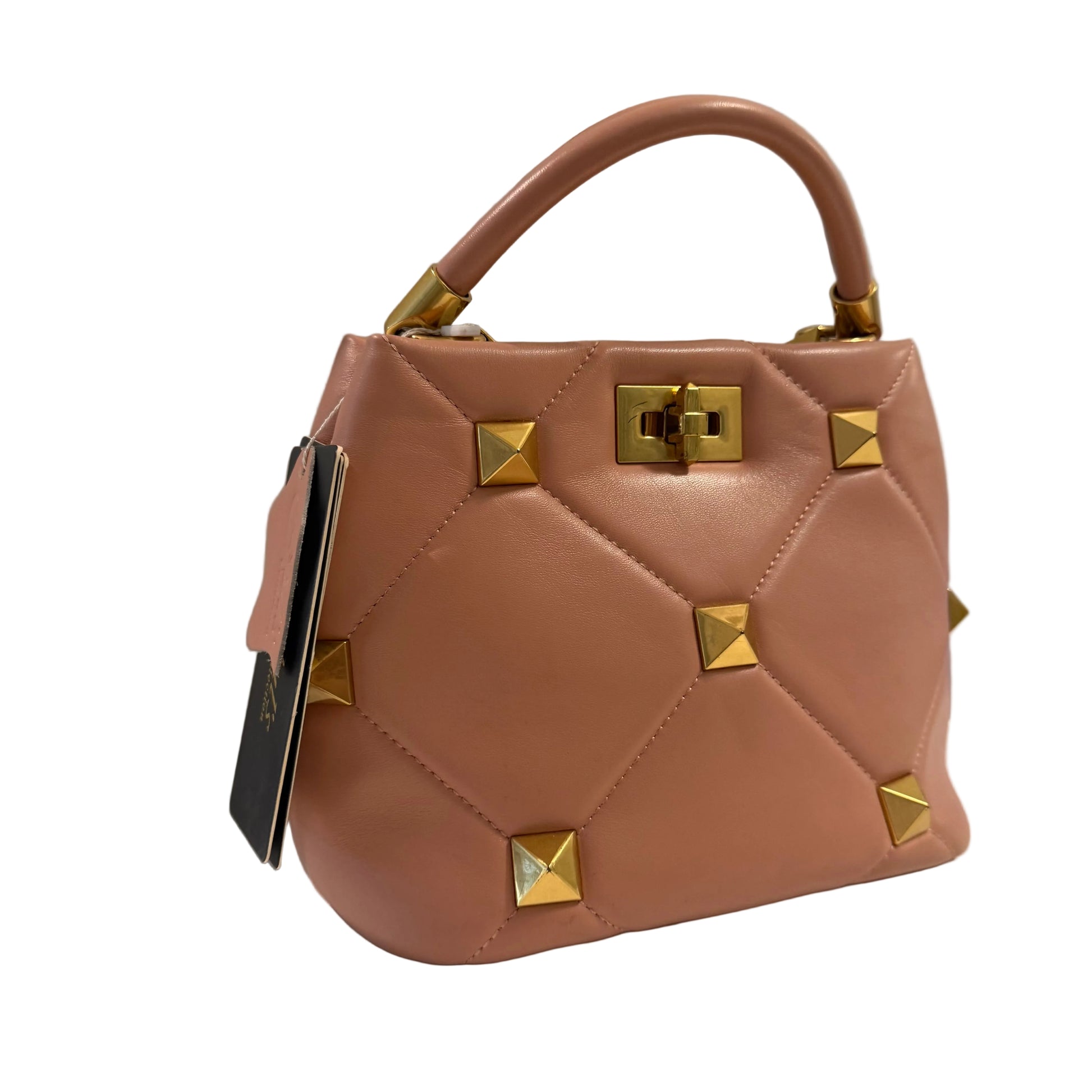 Brown handbag with gold studs on a neutral background