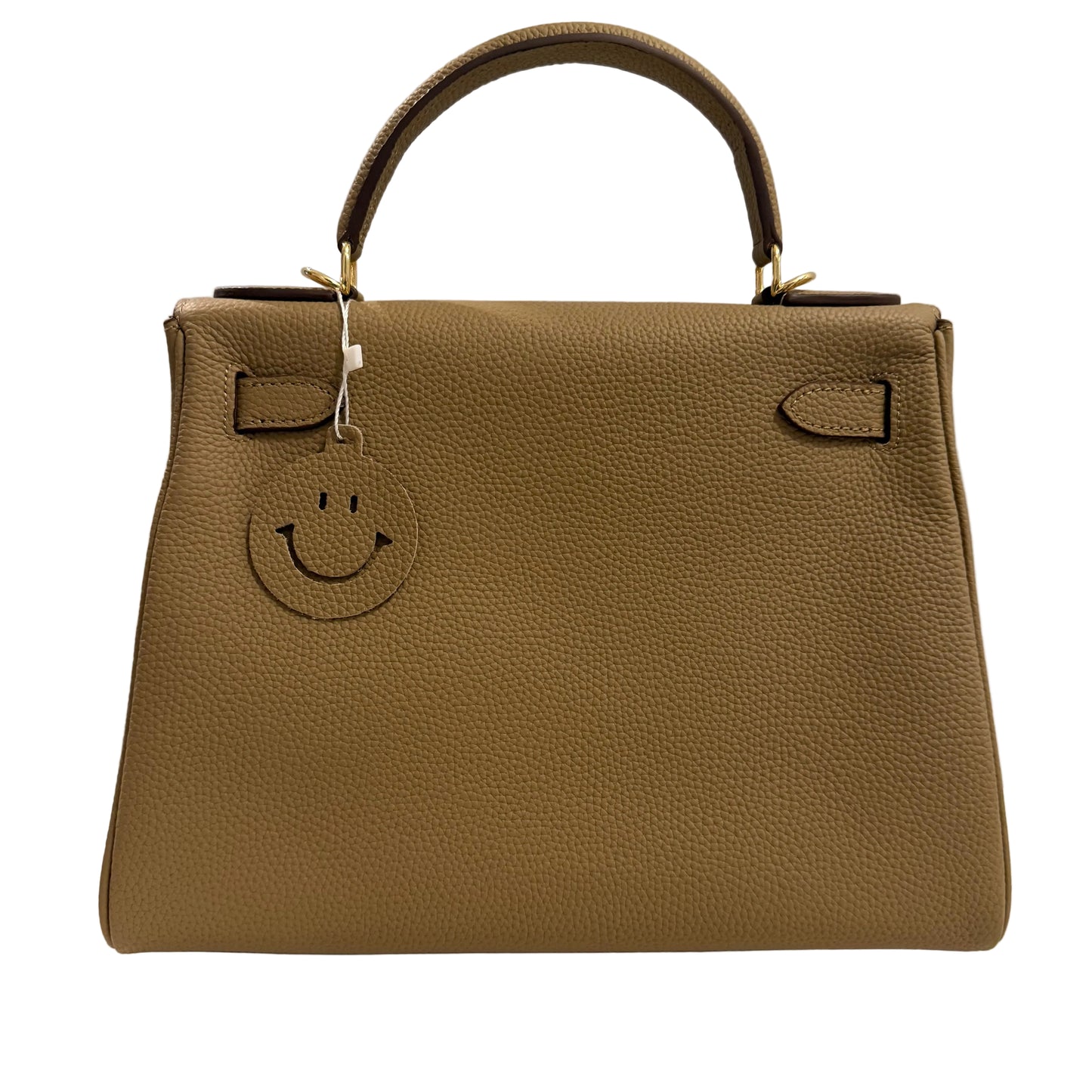 Brown handbag with a smiley face emblem on a light gray background
