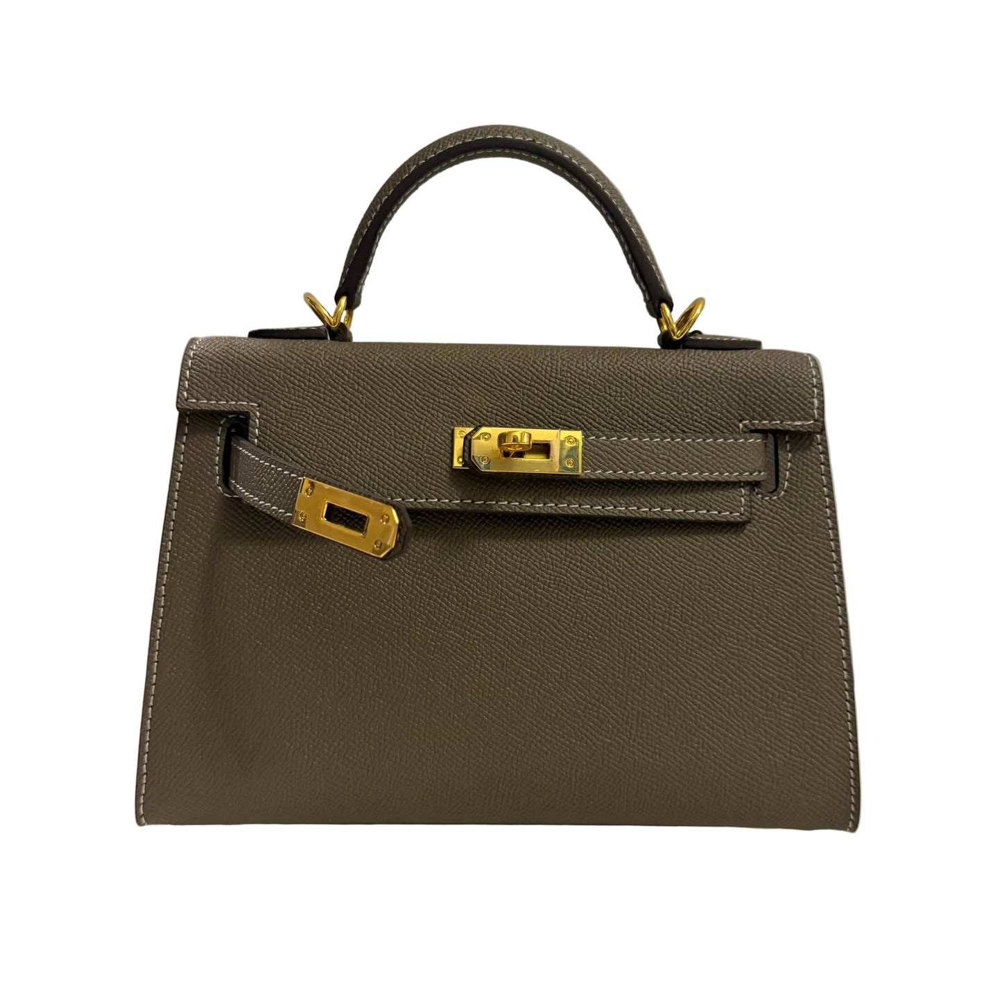 Brown handbag with gold hardware on a neutral background