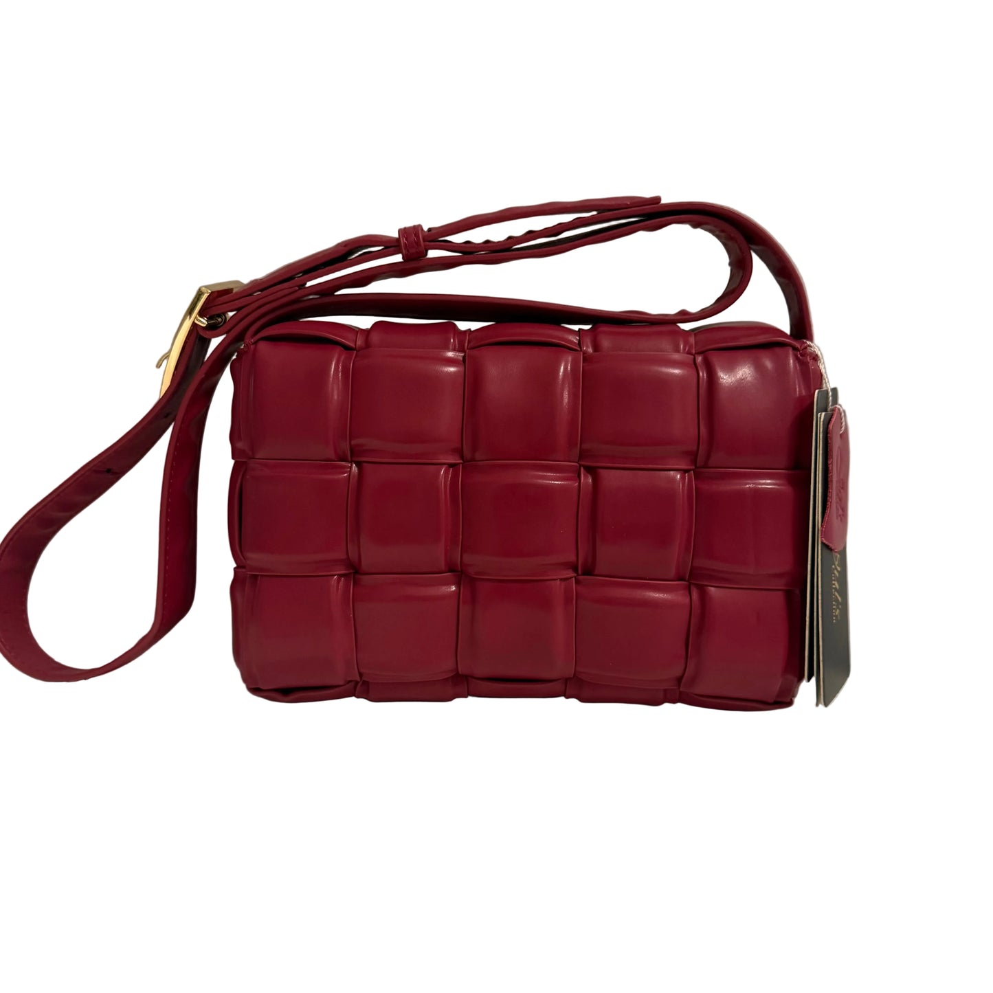 Red woven handbag with a strap on a neutral background
