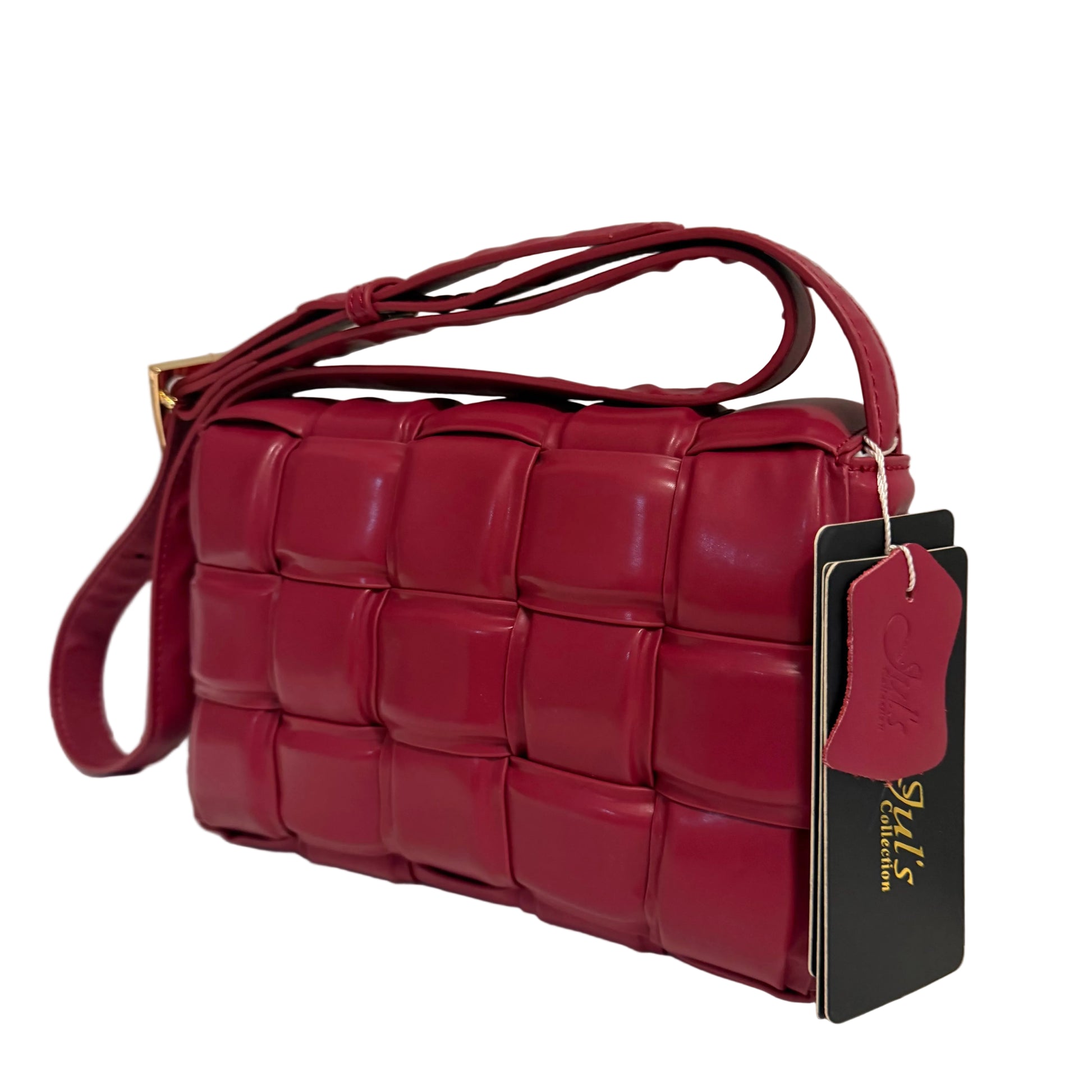 Red woven handbag with a tag on a light background