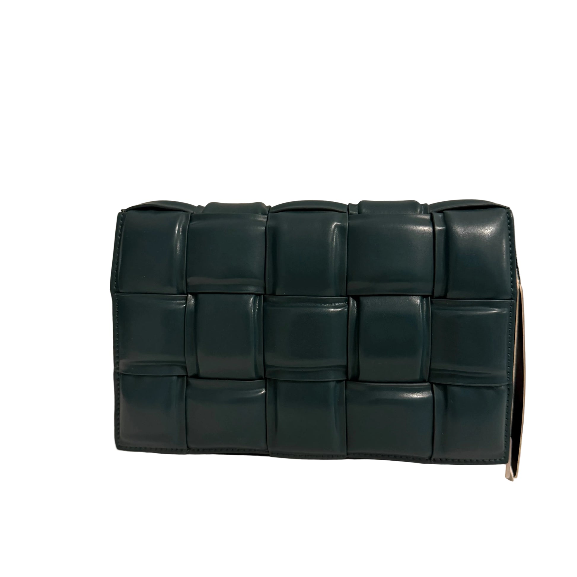 Green woven clutch bag on a beige background