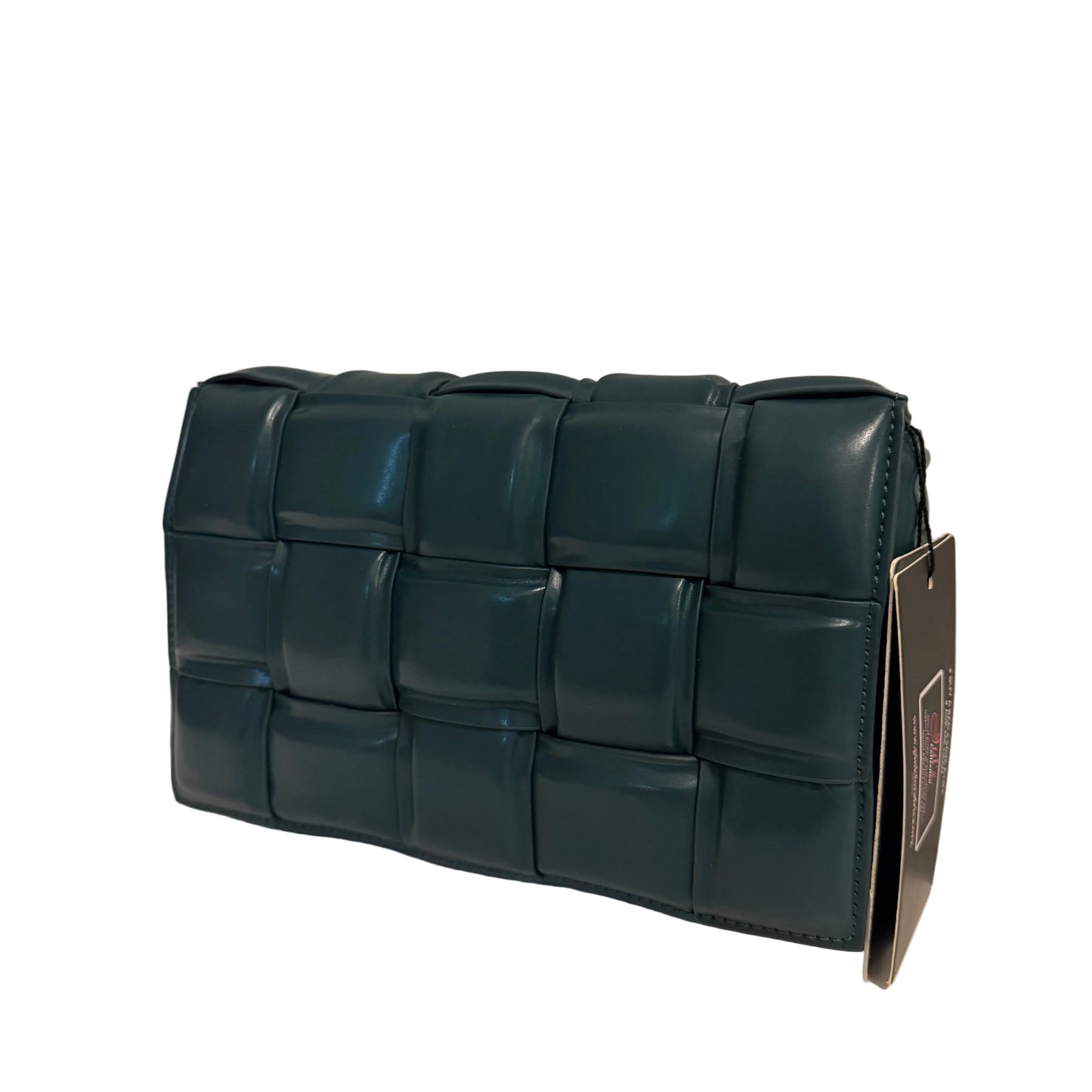 Green woven handbag on a light surface with a neutral background