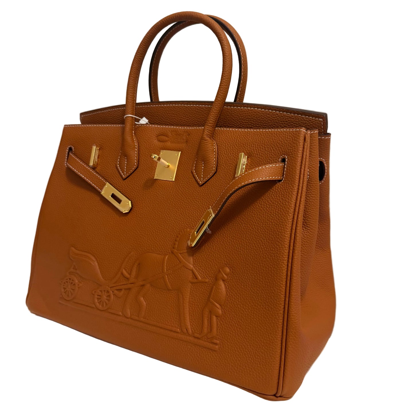 Brown leather handbag with gold hardware on a white surface