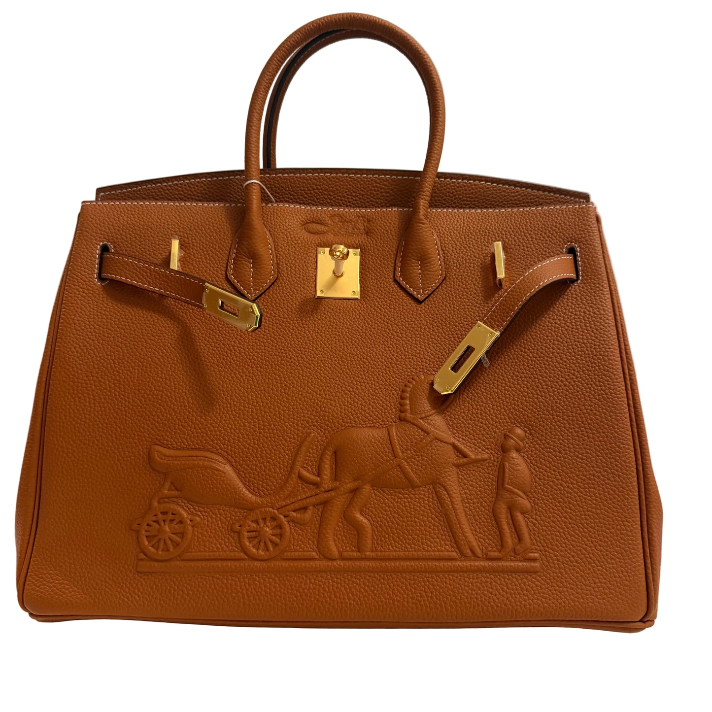 Brown leather handbag with gold hardware and embossed design on a neutral background