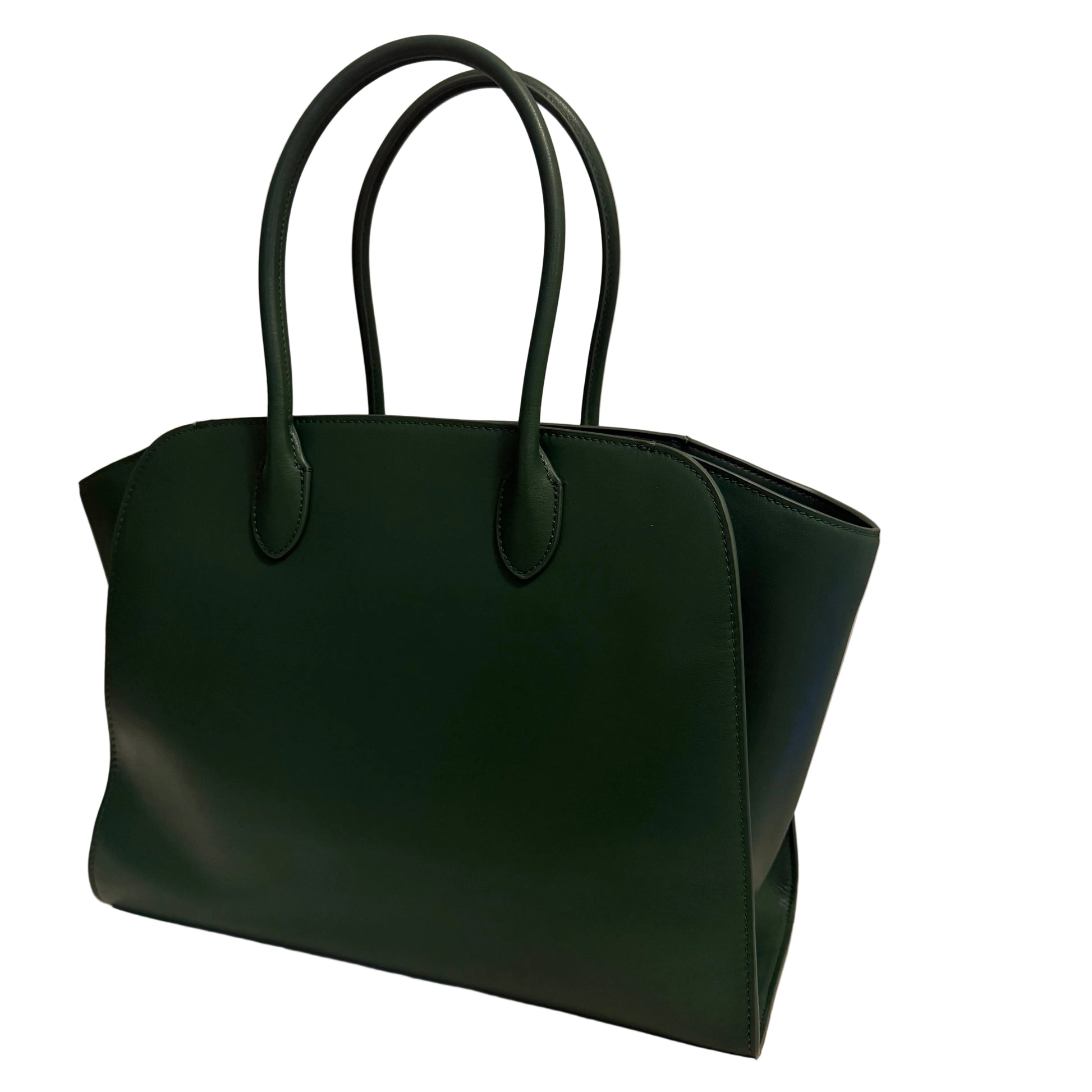 Green handbag on a light surface with a neutral background