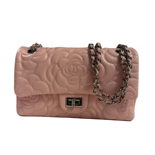 Pink quilted handbag with a chain strap on a neutral background