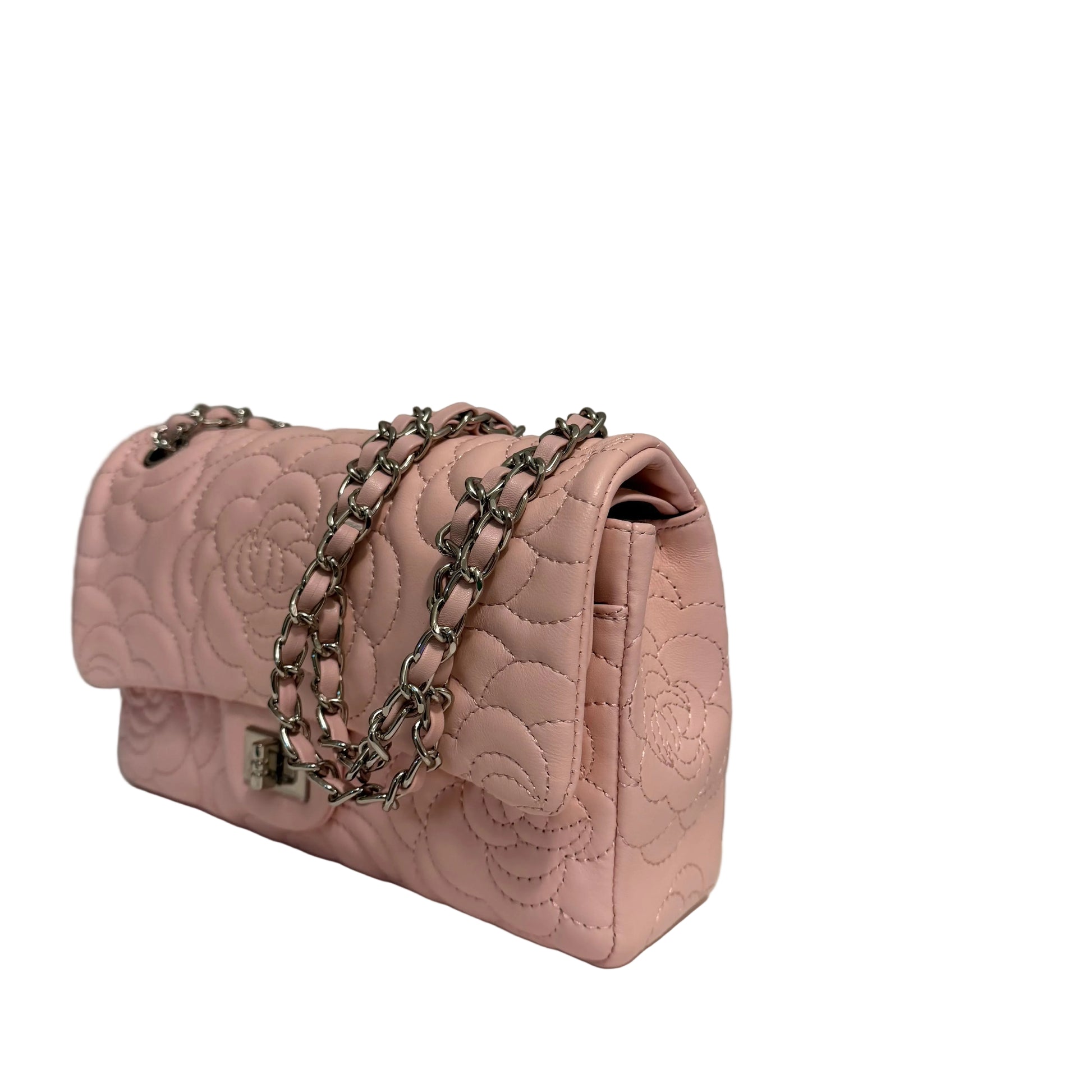 Pink quilted handbag with a chain strap on a gray background