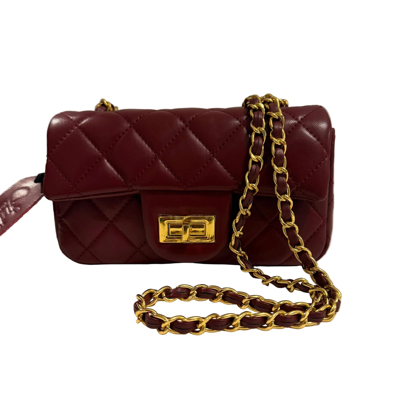 Maroon quilted handbag with gold chain strap on a white surface