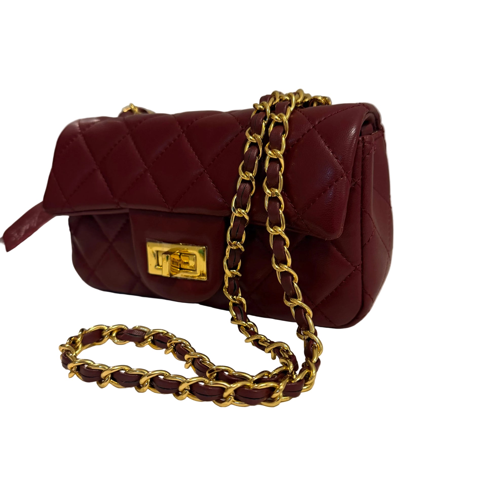 Red handbag with gold chain strap on a light surface