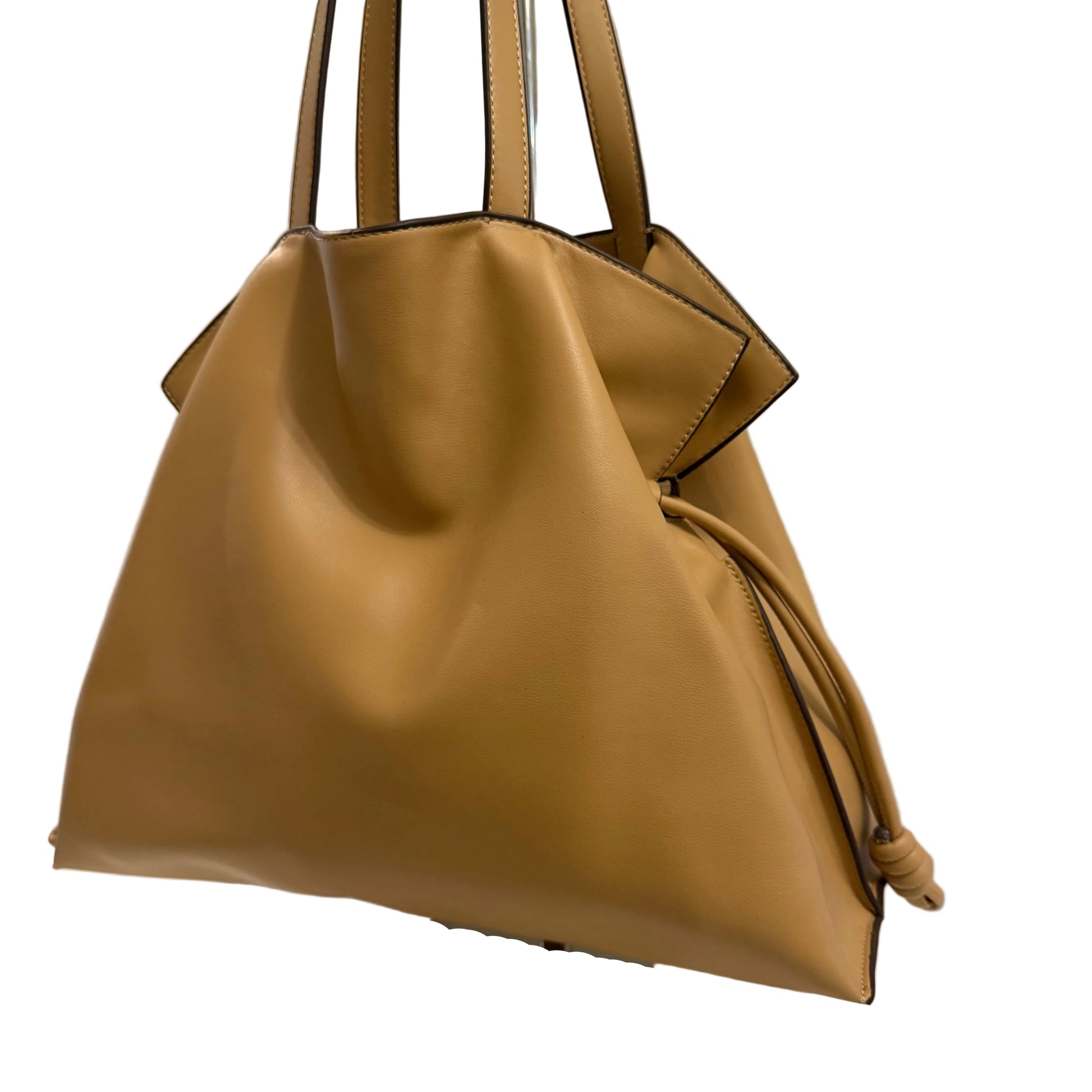 Brown handbag on a mannequin against a neutral background