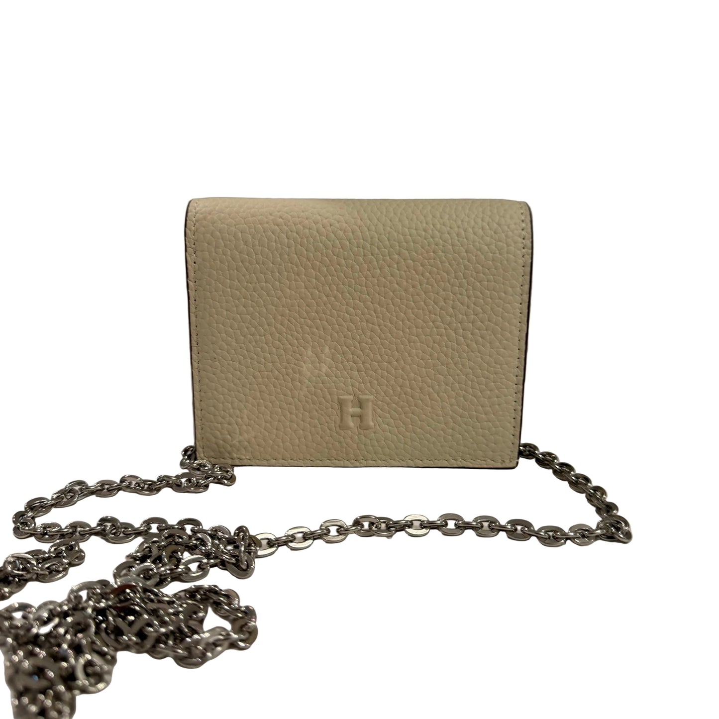 Beige handbag with a chain detail on a neutral background