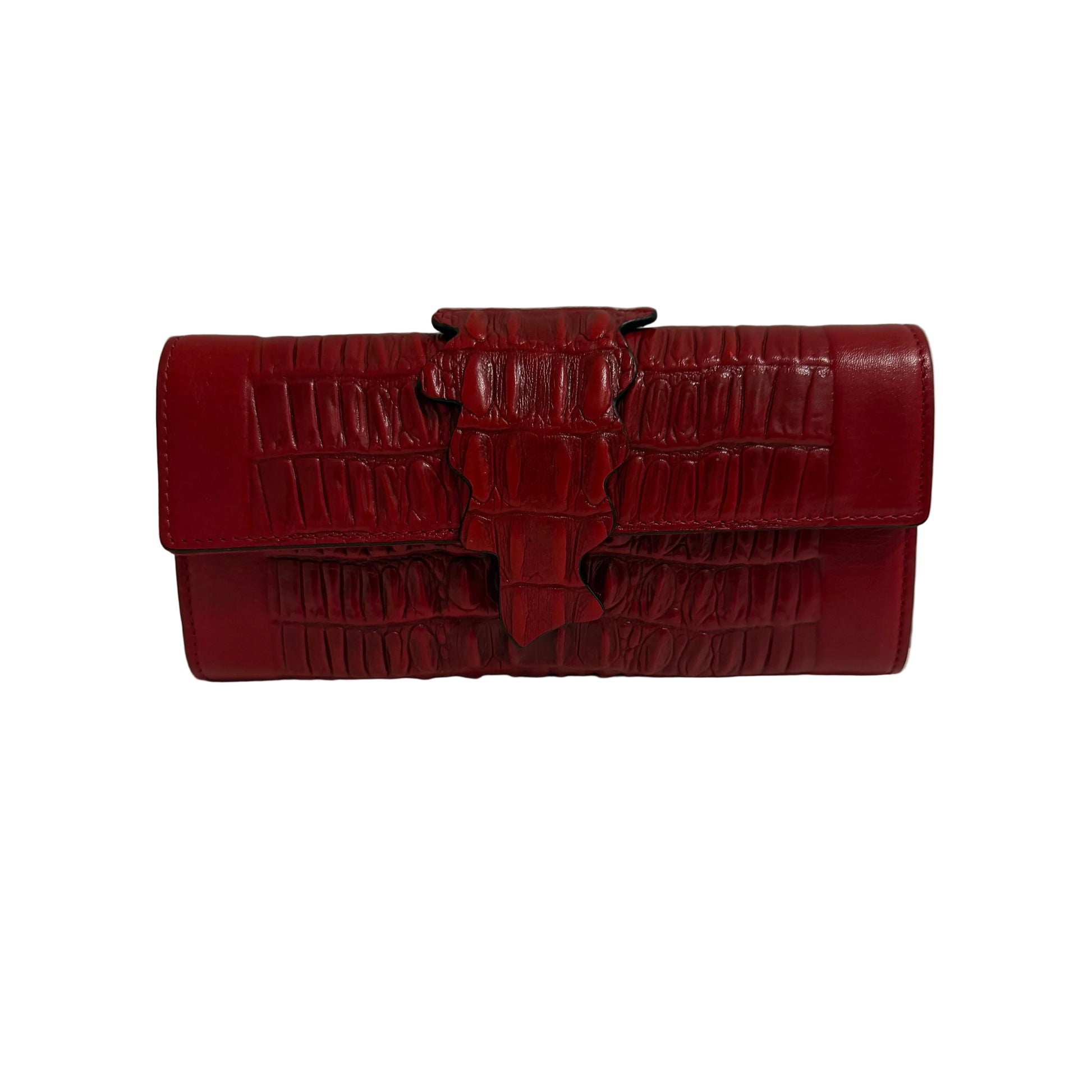 Red crocodile-patterned handbag on a white surface with a gray background