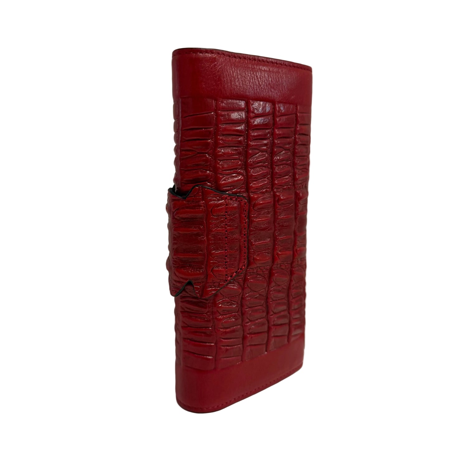 Red crocodile-patterned wallet on a white surface with a gray background