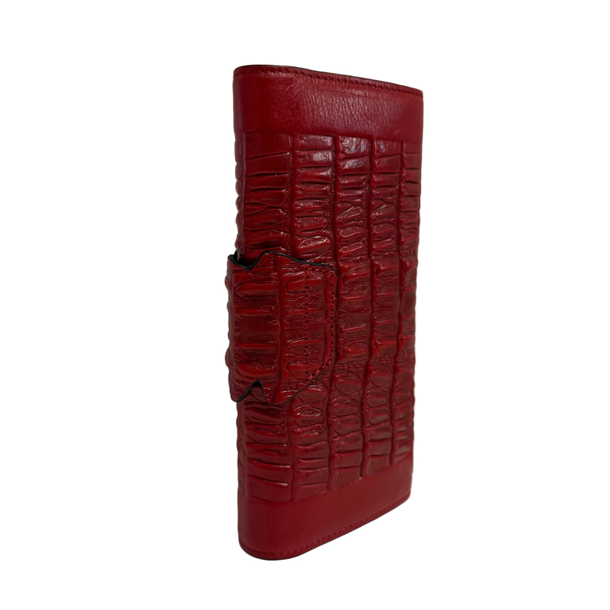 Red crocodile-patterned wallet on a white surface with a gray background