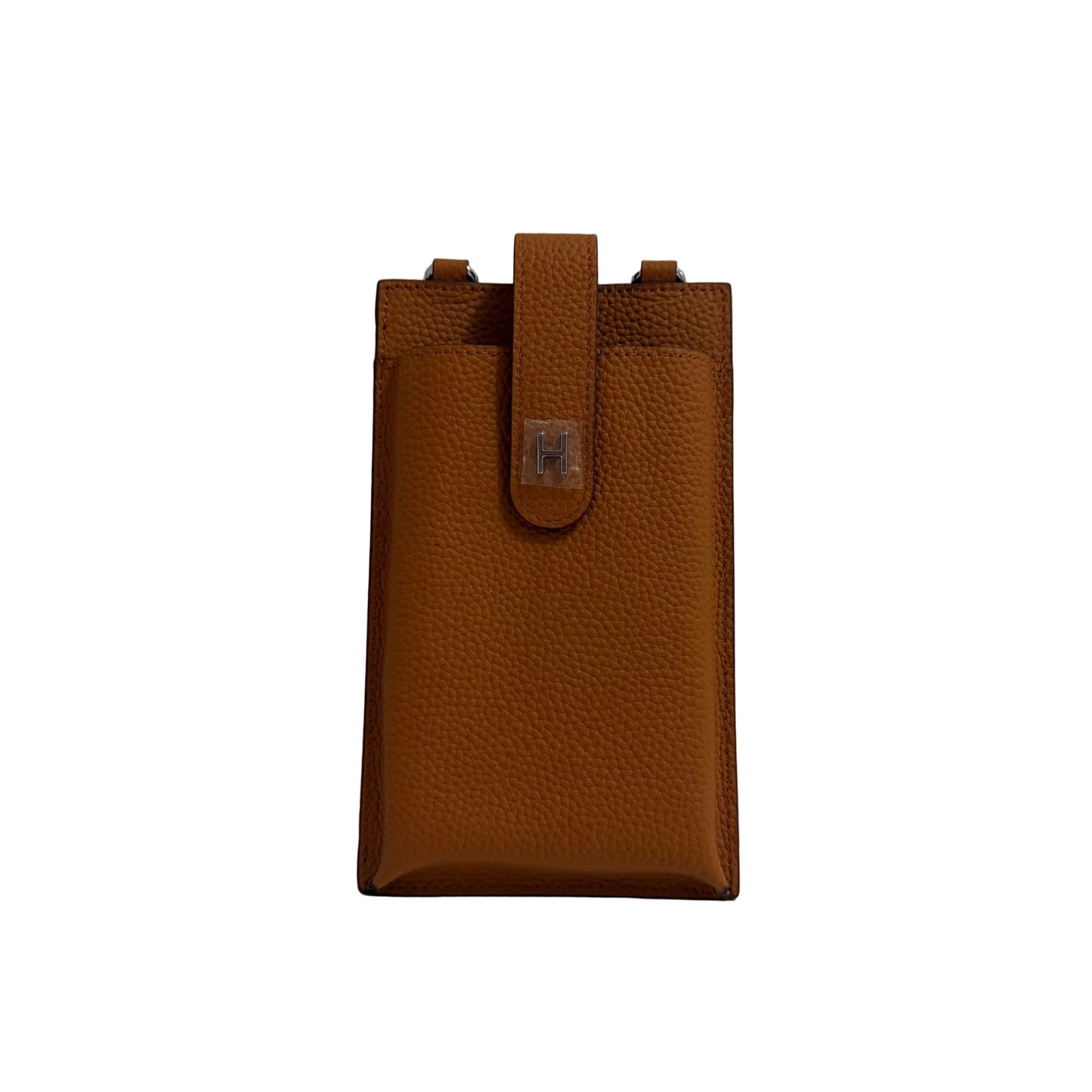 Brown leather pouch on a white surface with a gray background