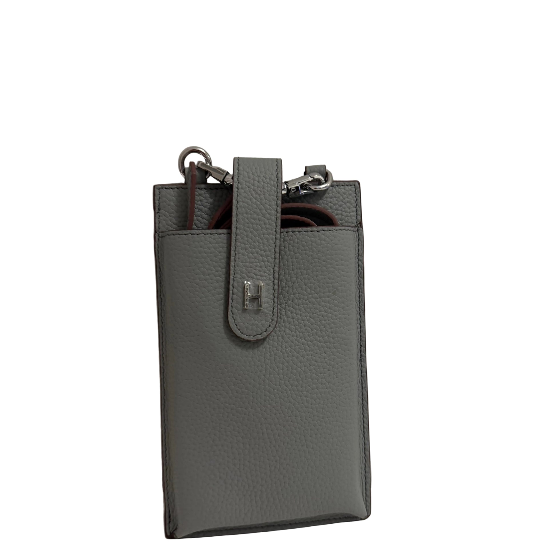 Gray leather phone case with a strap on a light gray background