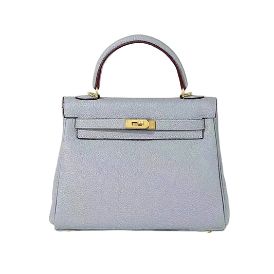 Light blue handbag with gold clasp on a white background