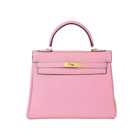 Pink handbag with gold hardware on a white background