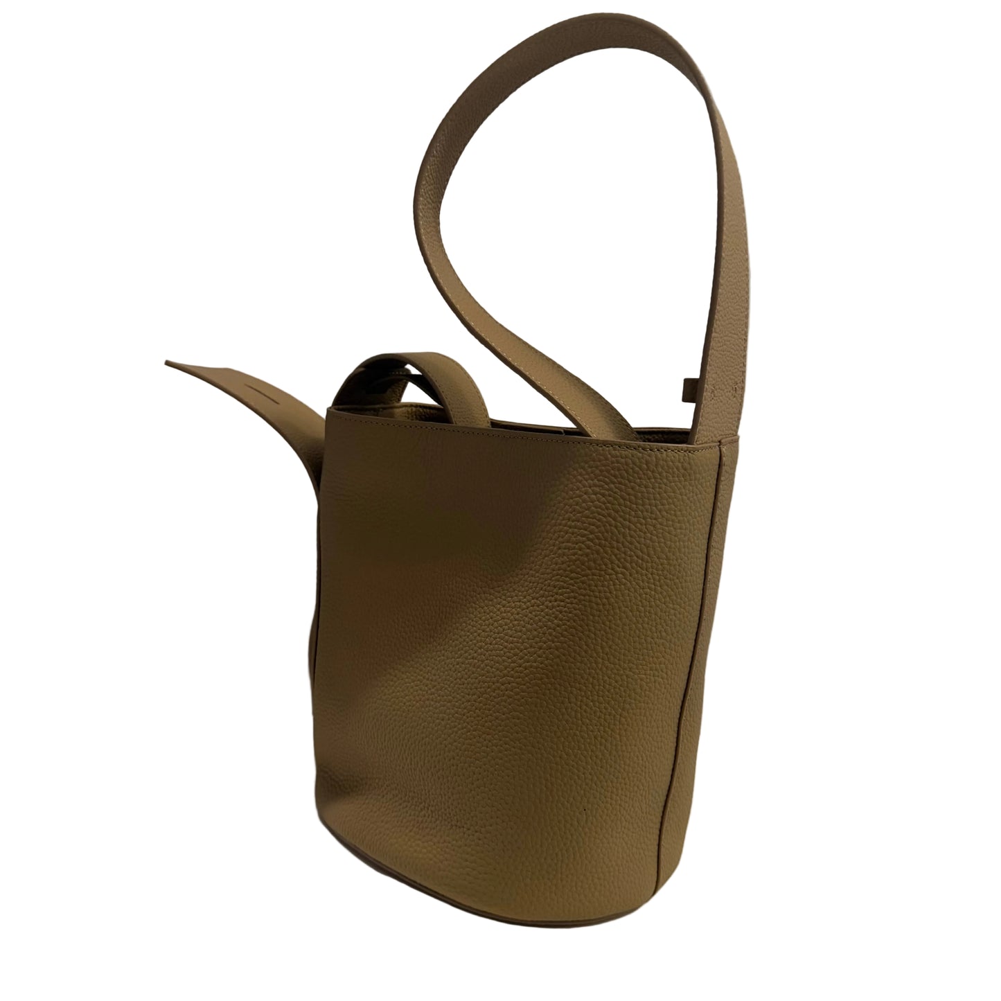 Brown leather handbag on a white surface with a gray background