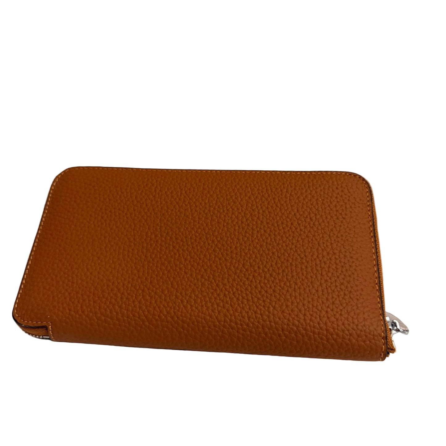 Brown leather wallet on a white surface with a light gray background