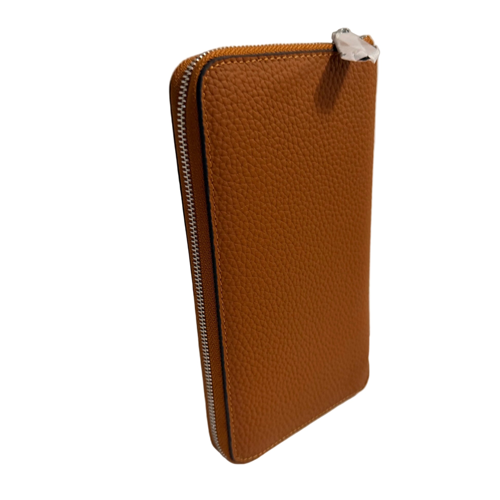 Brown leather wallet with a zipper on a white surface and light gray background