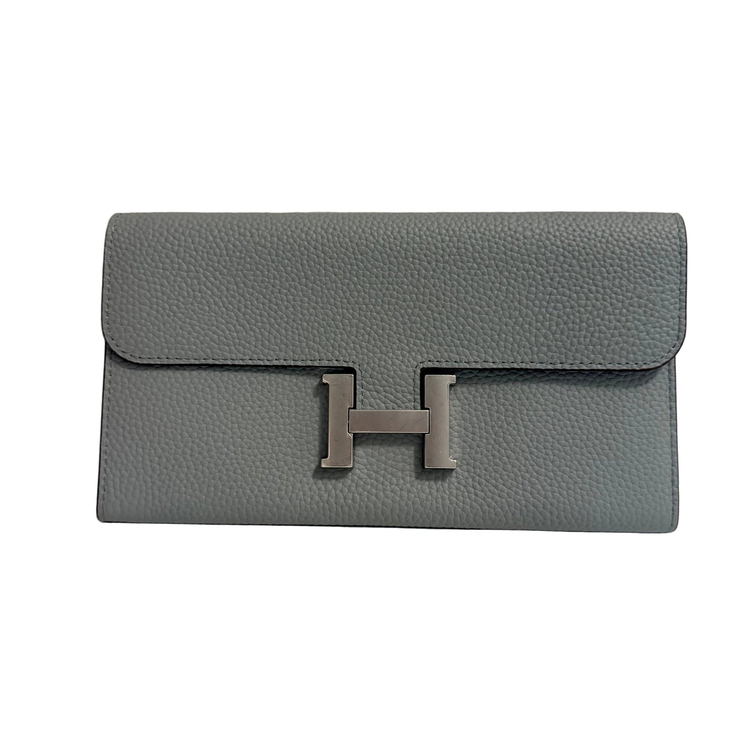 Gray clutch bag with a silver 'H' emblem on a light gray background