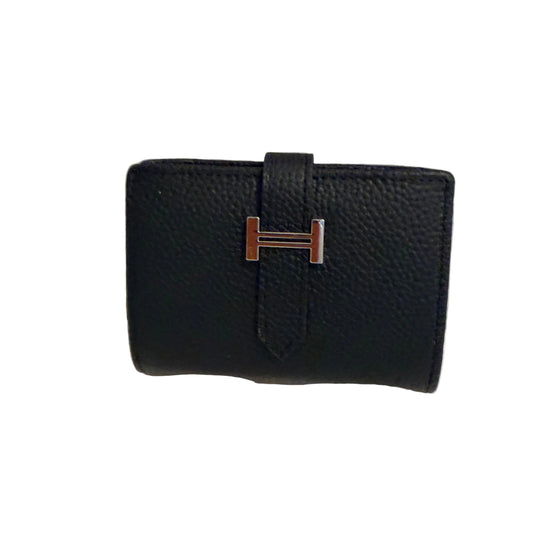 Black leather wallet with a silver logo on a white surface and light gray background