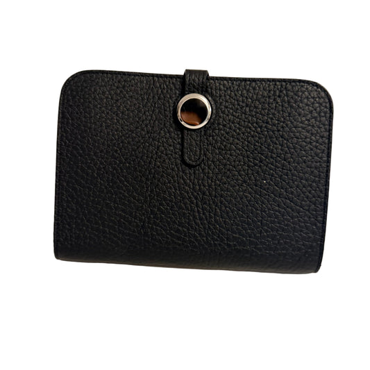 Black leather wallet with a metallic clasp on a light beige background