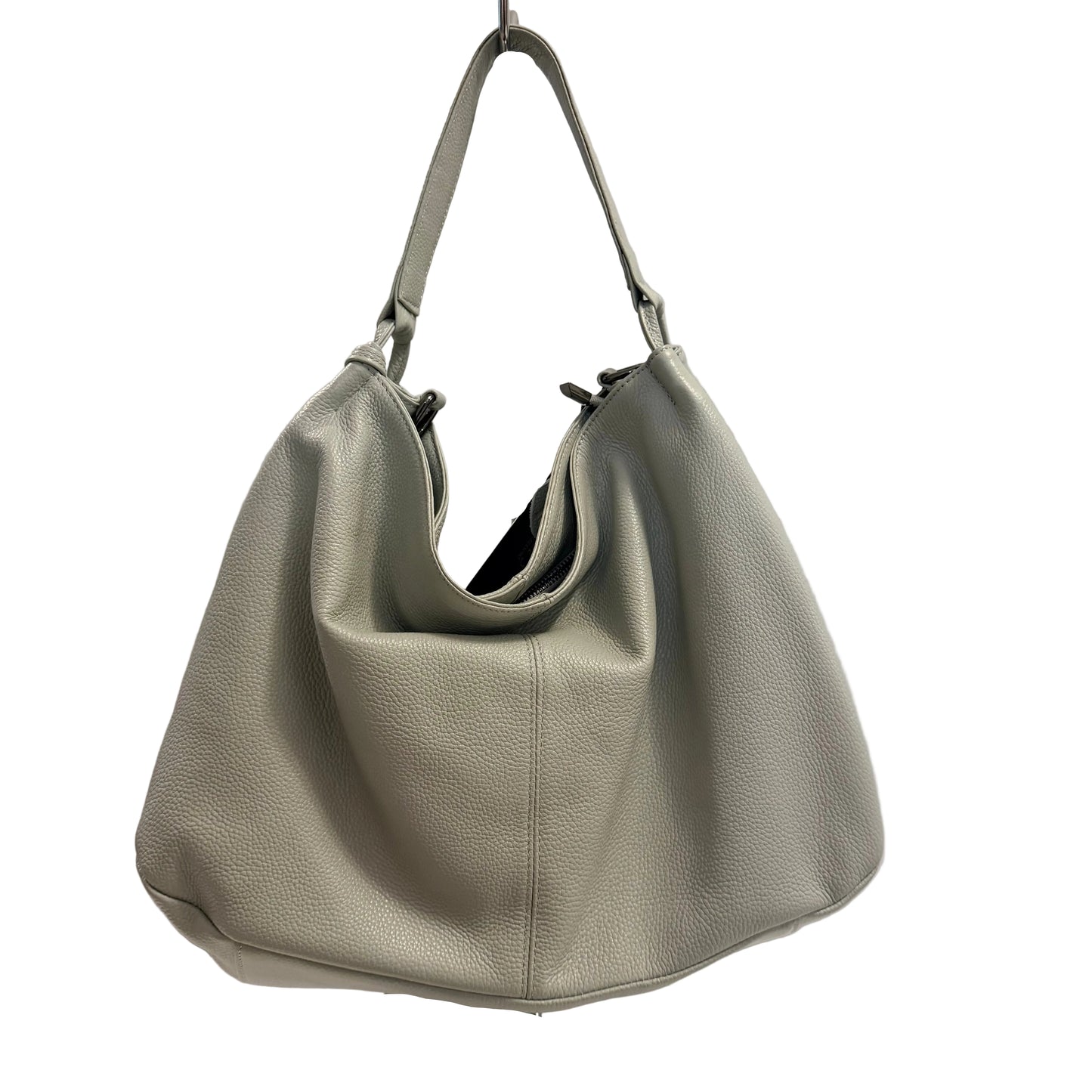 Gray handbag on a white pedestal against a light gray background