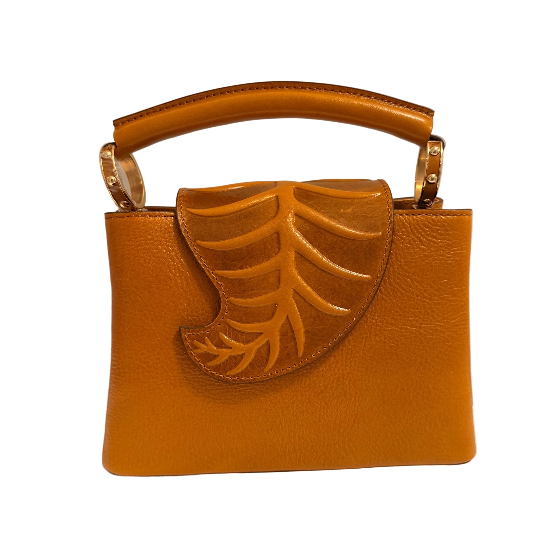 Brown leather handbag with leaf design on a neutral background