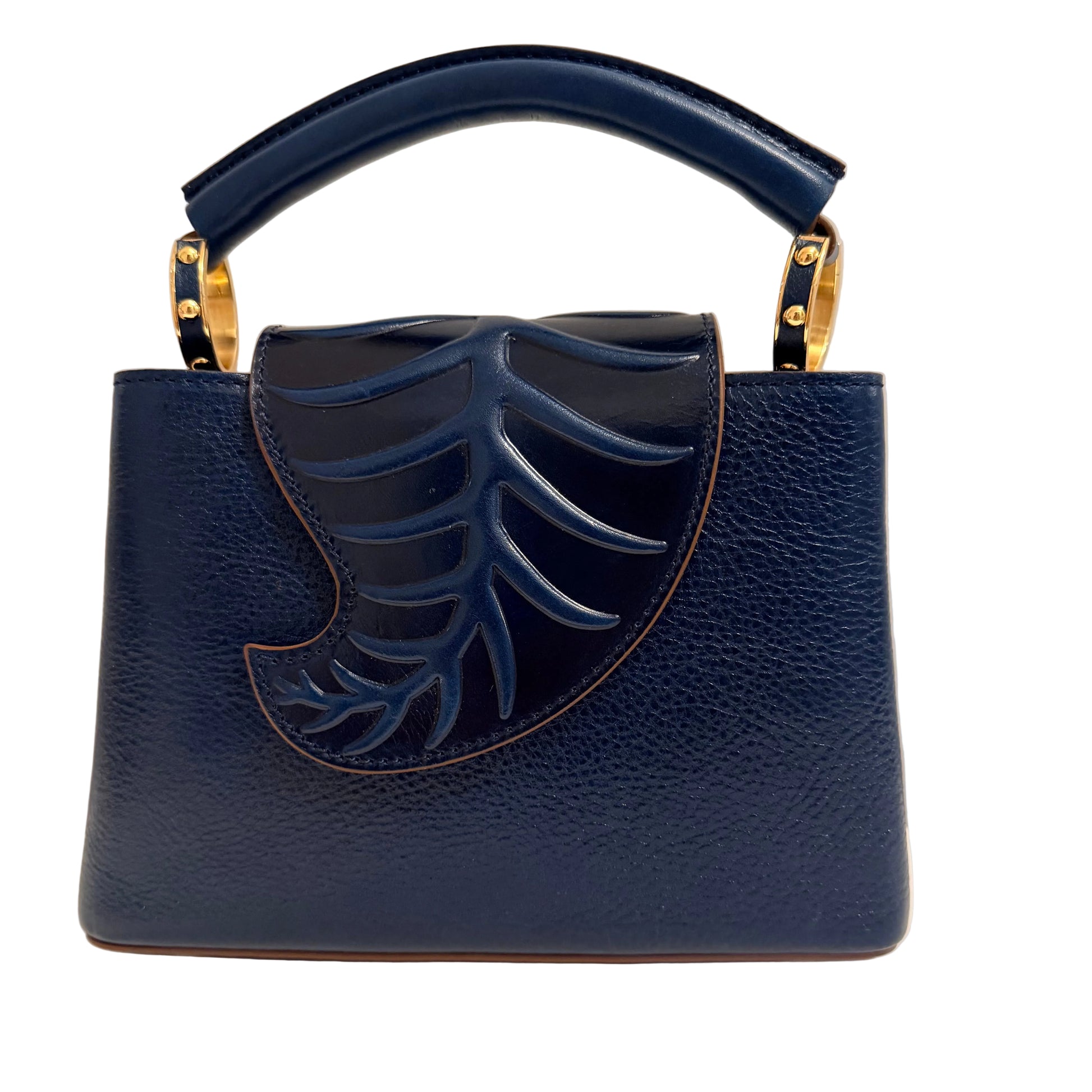 Blue handbag with leaf design and gold accents on a neutral background